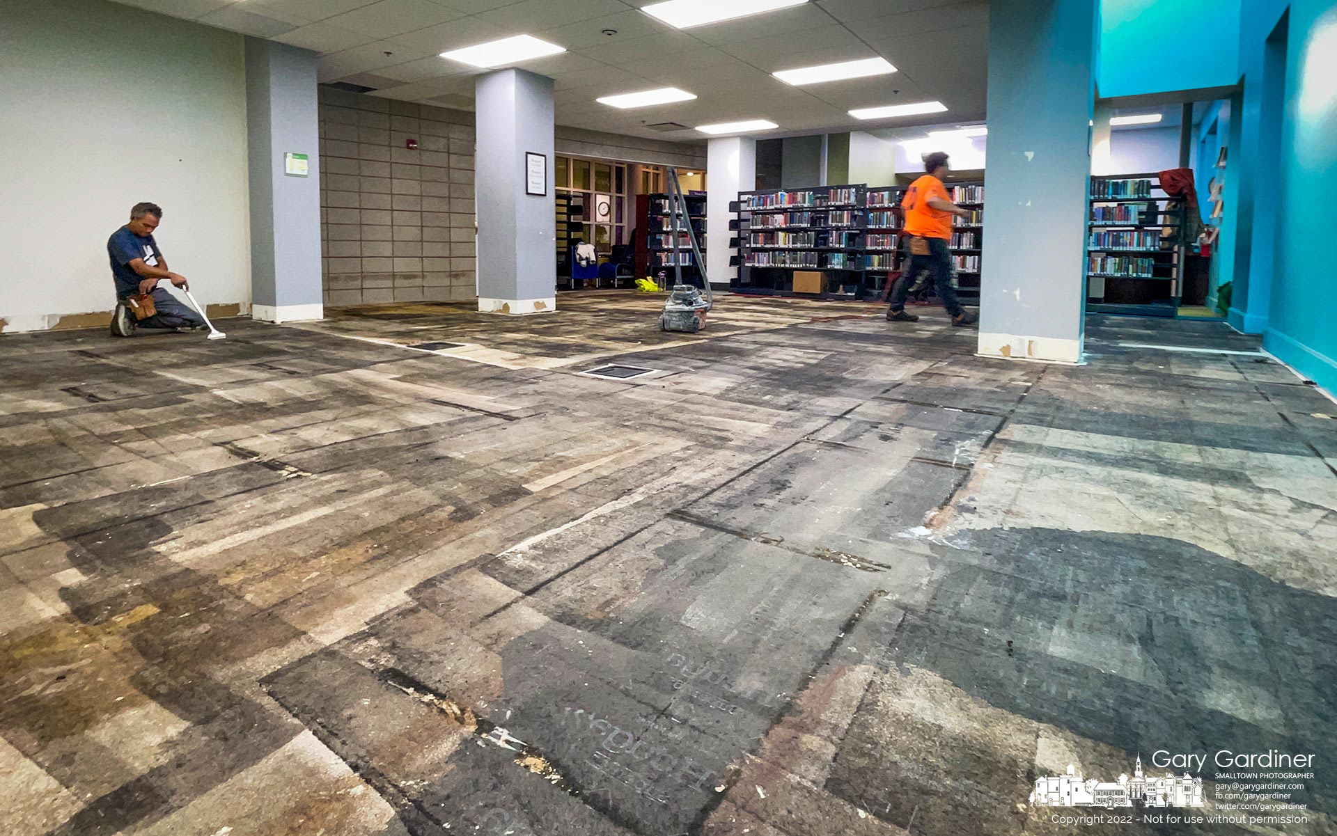 A carpet crew began replacing the carpet in the teen section of the library by removing the old multi-colored square tiles before prepping the surface for a new, more sturdy, and certainly cleaner carpet. My Final Photo for December 12, 2022.