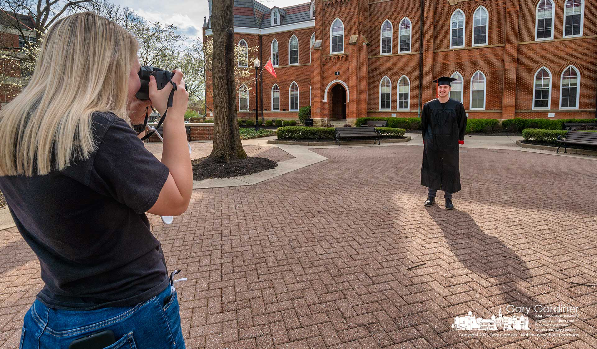 An Otterbein graduating senior poses for his fiancé in front of Towers Hall as he prepares for commencement ceremonies in May. My Final Photo for April 7, 2021.