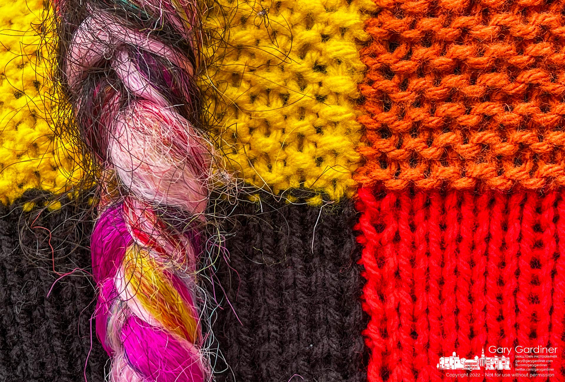 A woman's fabric-braided hair hangs across her colorful sweater during a discussion of Westerville's importance in the Underground Railroad at the Hanby House. My Final Photo for September 25, 2022.