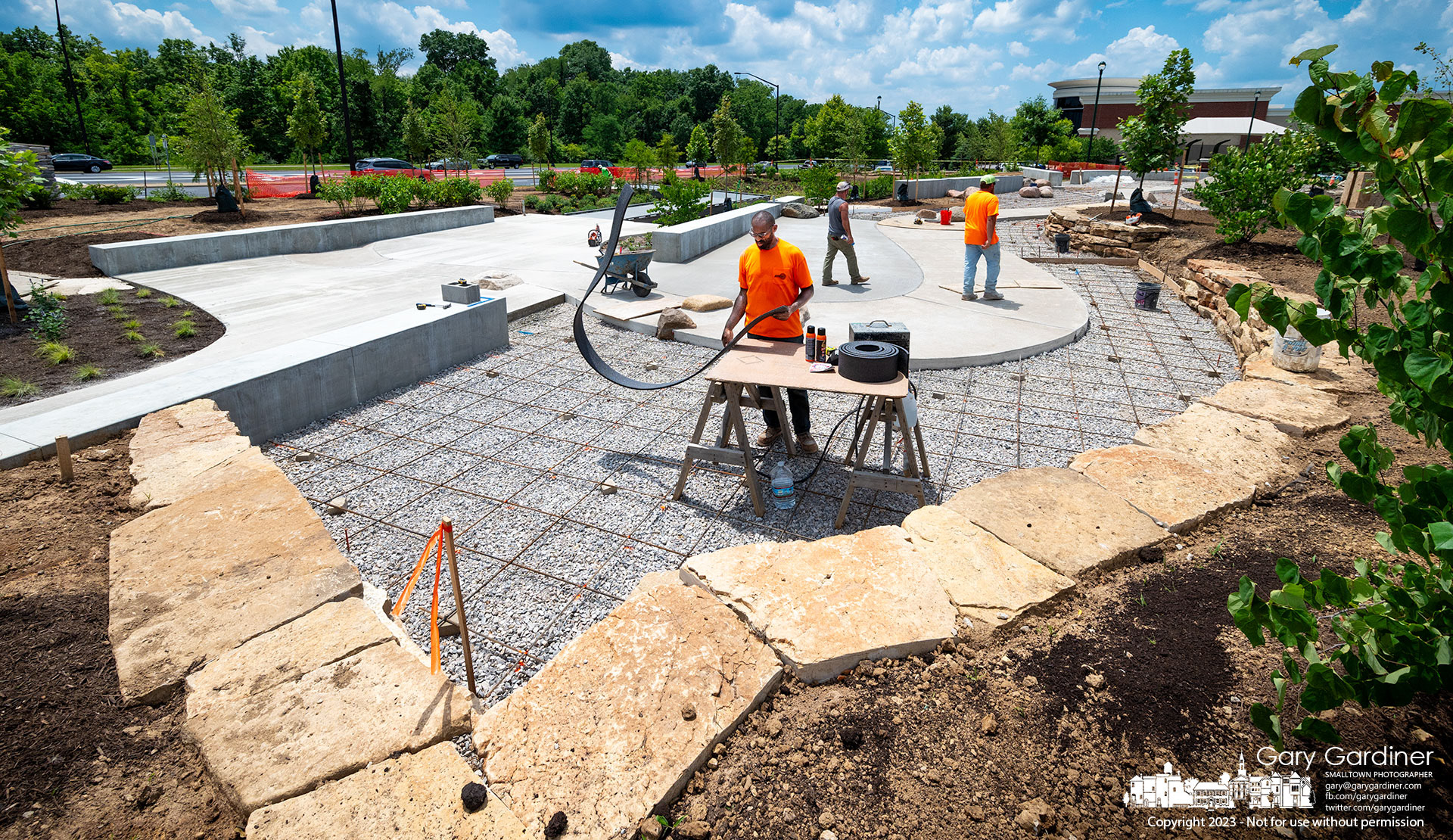 A worker cuts material for expansion joints in the concrete pad being poured as part of the river setting at Sycamore Park dedicated to Westerville's participation in the Underground  Railroad. The park, at the northwest corner of Polaris Parkway and Africa Road, is expected to be dedicated in August. My Final Photo for July 12, 2023.
