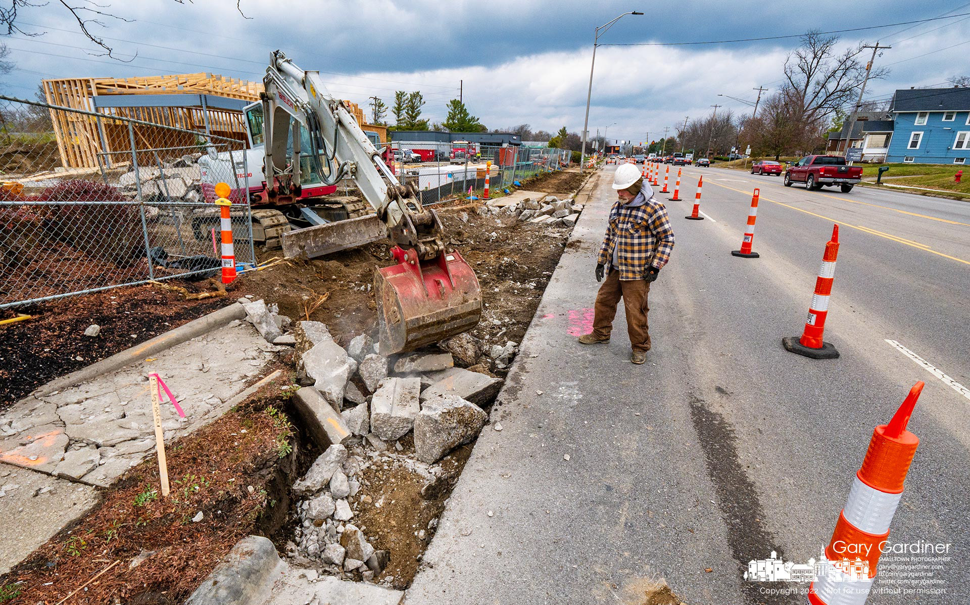 A crew removes the existing curb and sidewalk to make way for a new curb cut for two drive-thru lanes for the new Dunkin' donut shop on South State Street. My Final Photo for November 16, 2022.