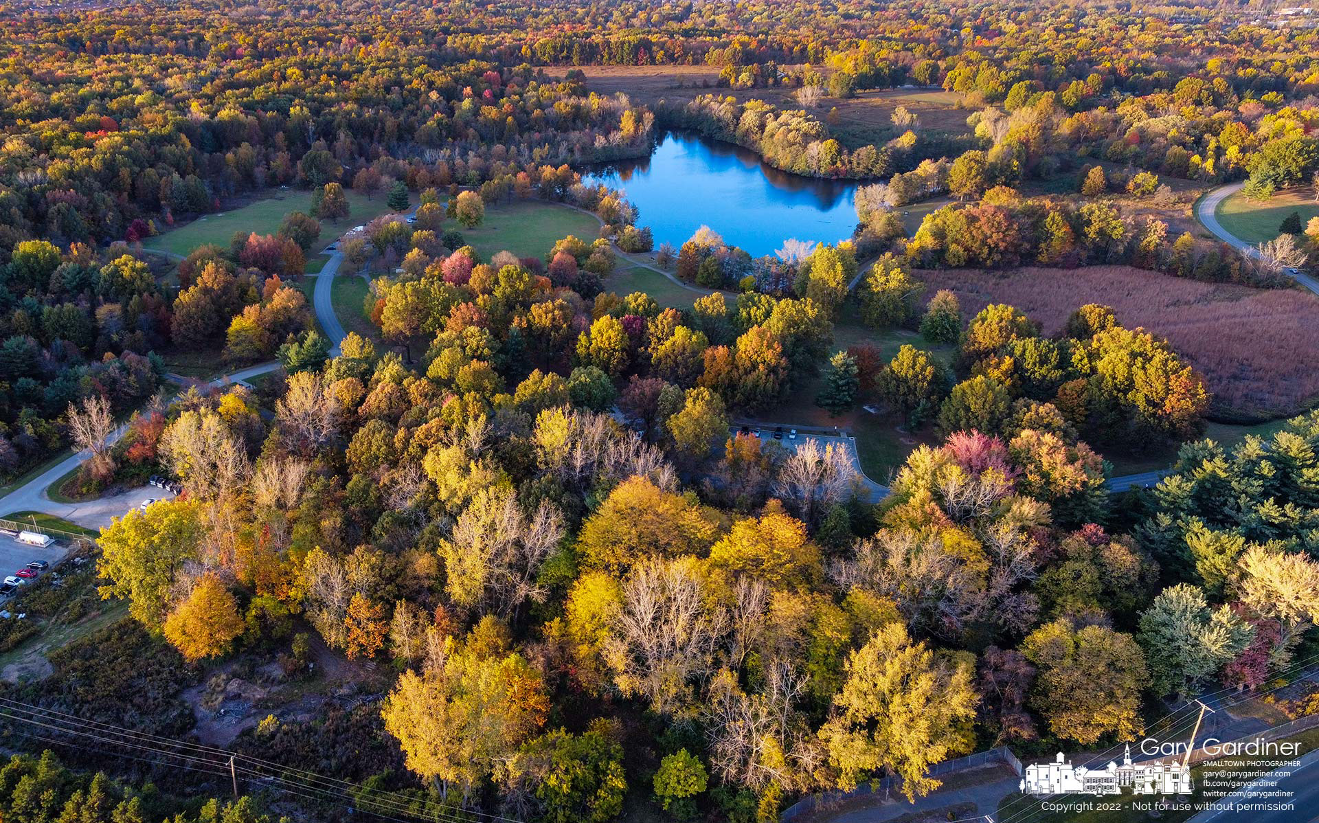Schrock Lake at Sharon Woods Metro Park offers a still blue spot in the center of fall colors. My Final Photo for October 14, 2022. Photo Copyright 2022 Gary Gardiner. Not to be used without written permission detailing exact usage. Photos from Gary Gardiner, may not be redistributed, resold, or displayed by any publication or person without written permission. Photo is copyright Gary Gardiner who owns all usage rights to the image.