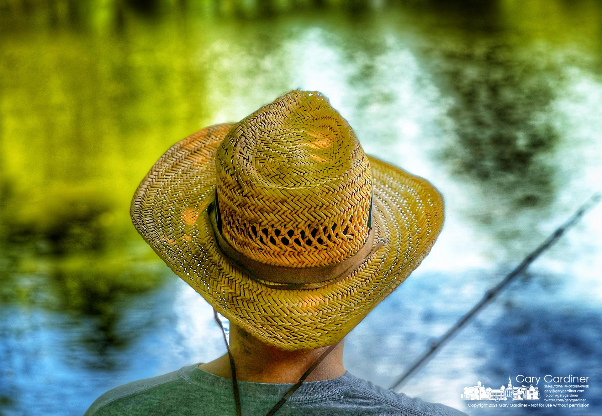 A fisherman wears a straw hat as protection from the sun as he fishes along the shoreline of Hoover Reservoir. My Final Photo for July 3, 2021.
