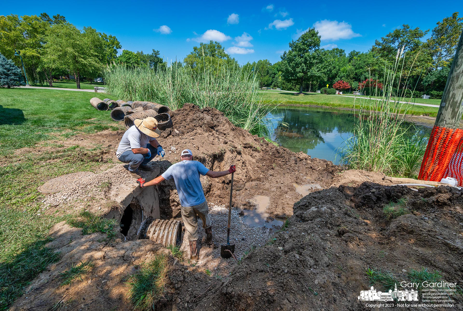 Westerville Parks workers replace damaged storm drain pipes at Heritage Park after partially draining and damming the ponds to keep backflow out of the excavated area. My Final Photo for August 22, 2023.   