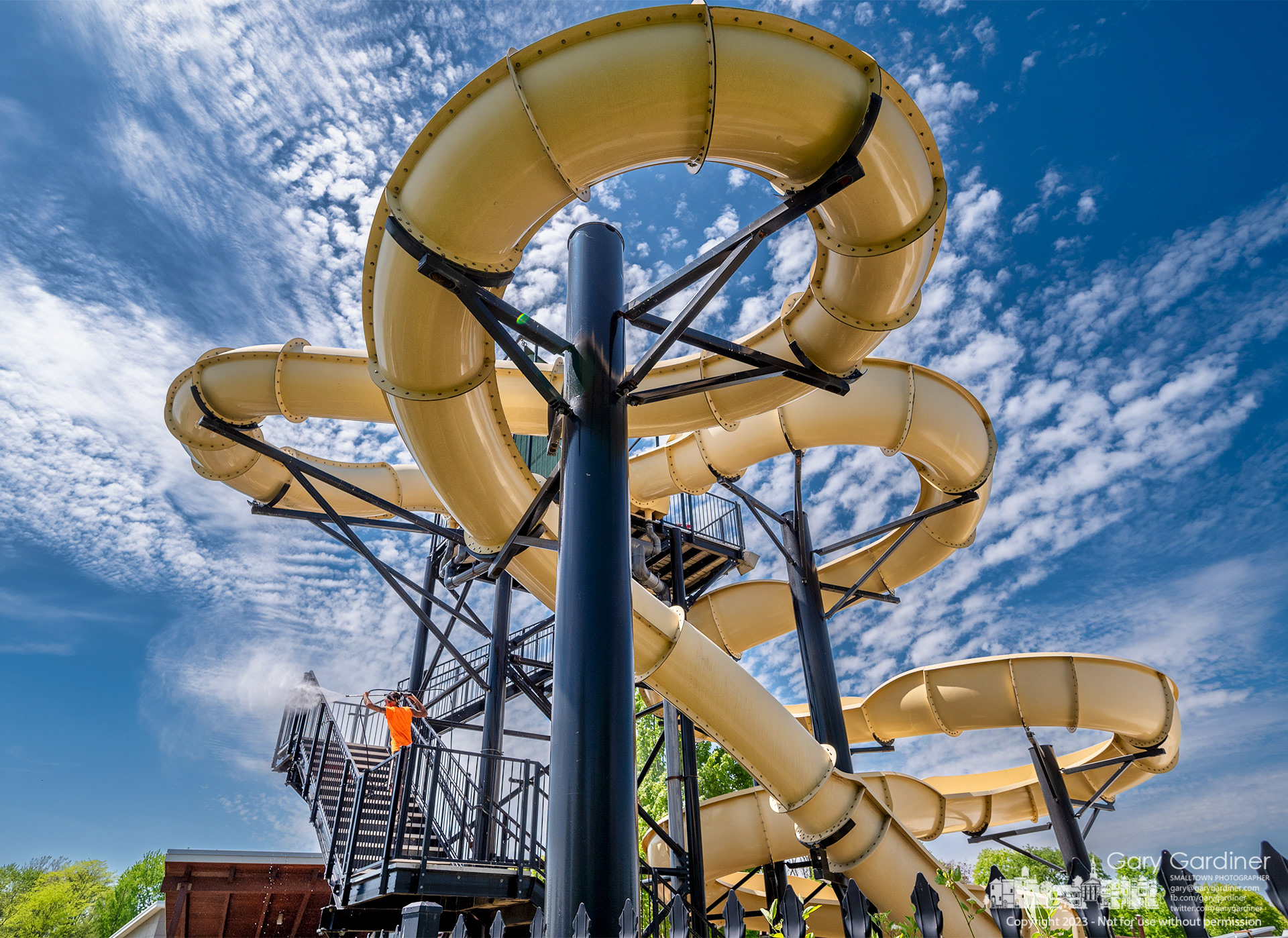 A work crew spray washes the stairs leading to the slides at Highlands Aquatic Park as the city parks department gets the pool ready for opening in just over two weeks. My Final Photo for May 11, 2023. 
