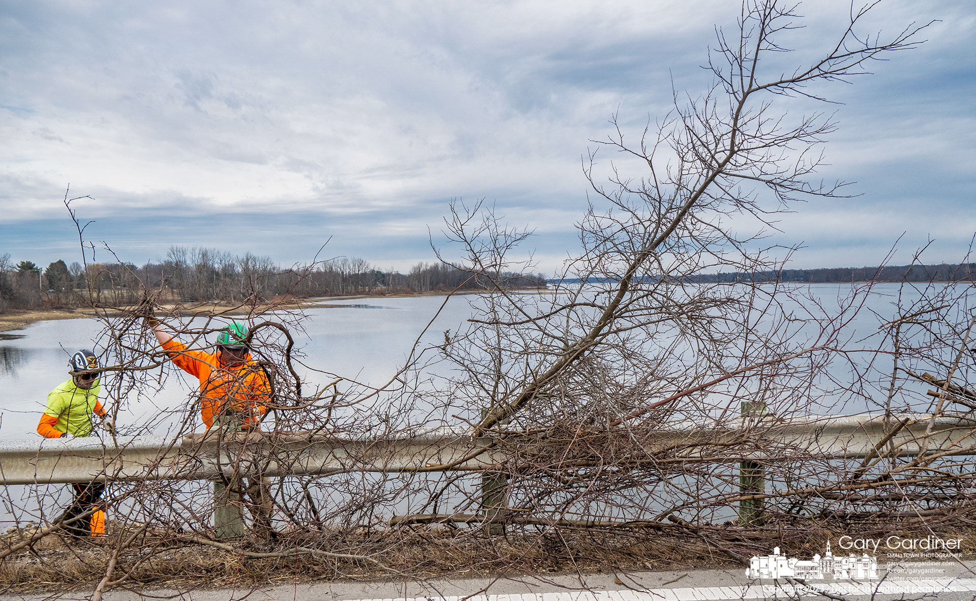A work crew removes trees and shrubs growing in rocks in the base of Smothers Road over Hoover Reservoir preventing the plant's roots from damaging the important structure and blocking views of the lake. My Final Photo for January 11, 2023.