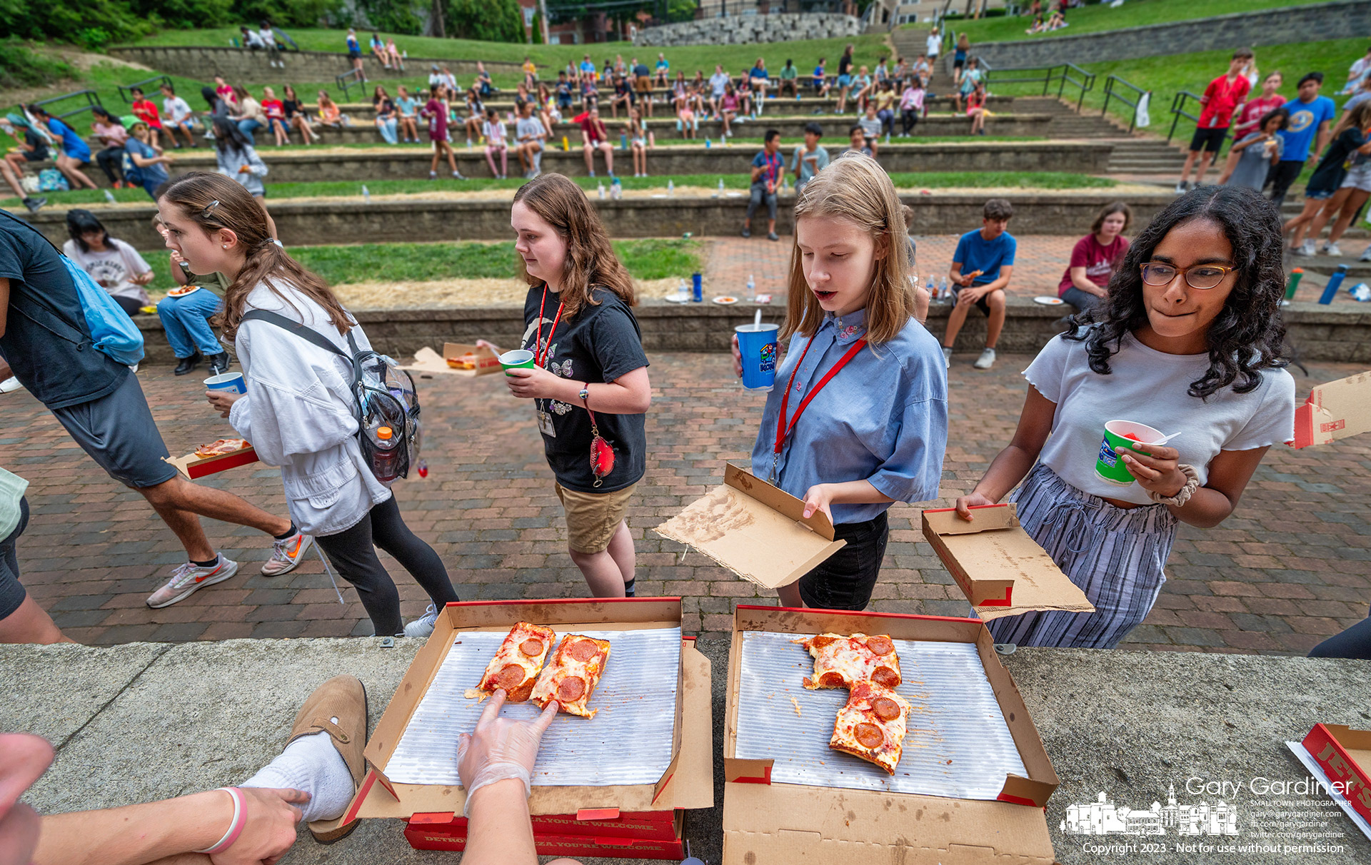 A youth group is treated to pizza for lunch in the amphitheater during an outing at Alum Creek Park North. My Final Photo for July 19, 2023. 