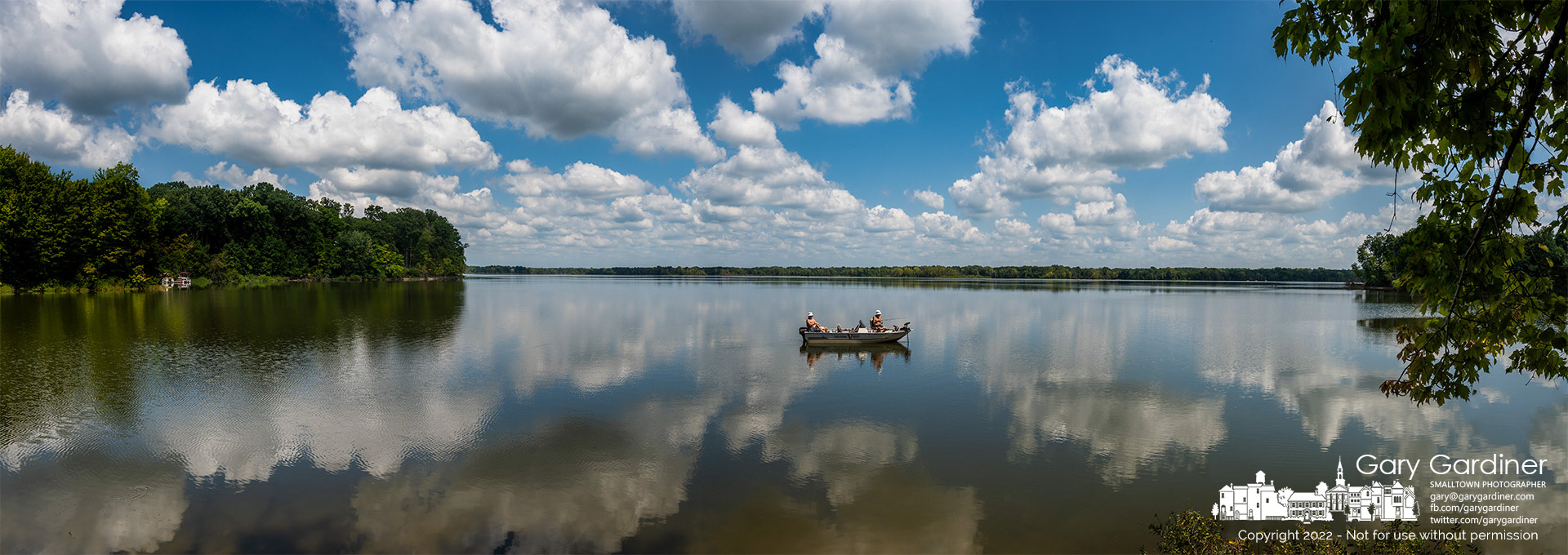 Two fishermen slowly troll the still waters of Hoover Reservoir near the Oxbow boat ramp on a near-perfect day of moderate temperatures, no wind, and light cloud cover. My Final Photo for August 24, 2022.