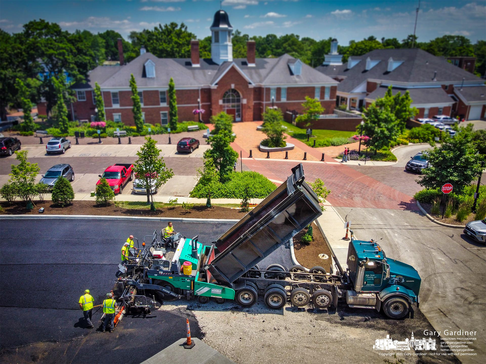 Contractors finish laying the first level of what will be six inches of asphalt to the new parking lot behind city hall. My Final Photo for June 14, 2021.
