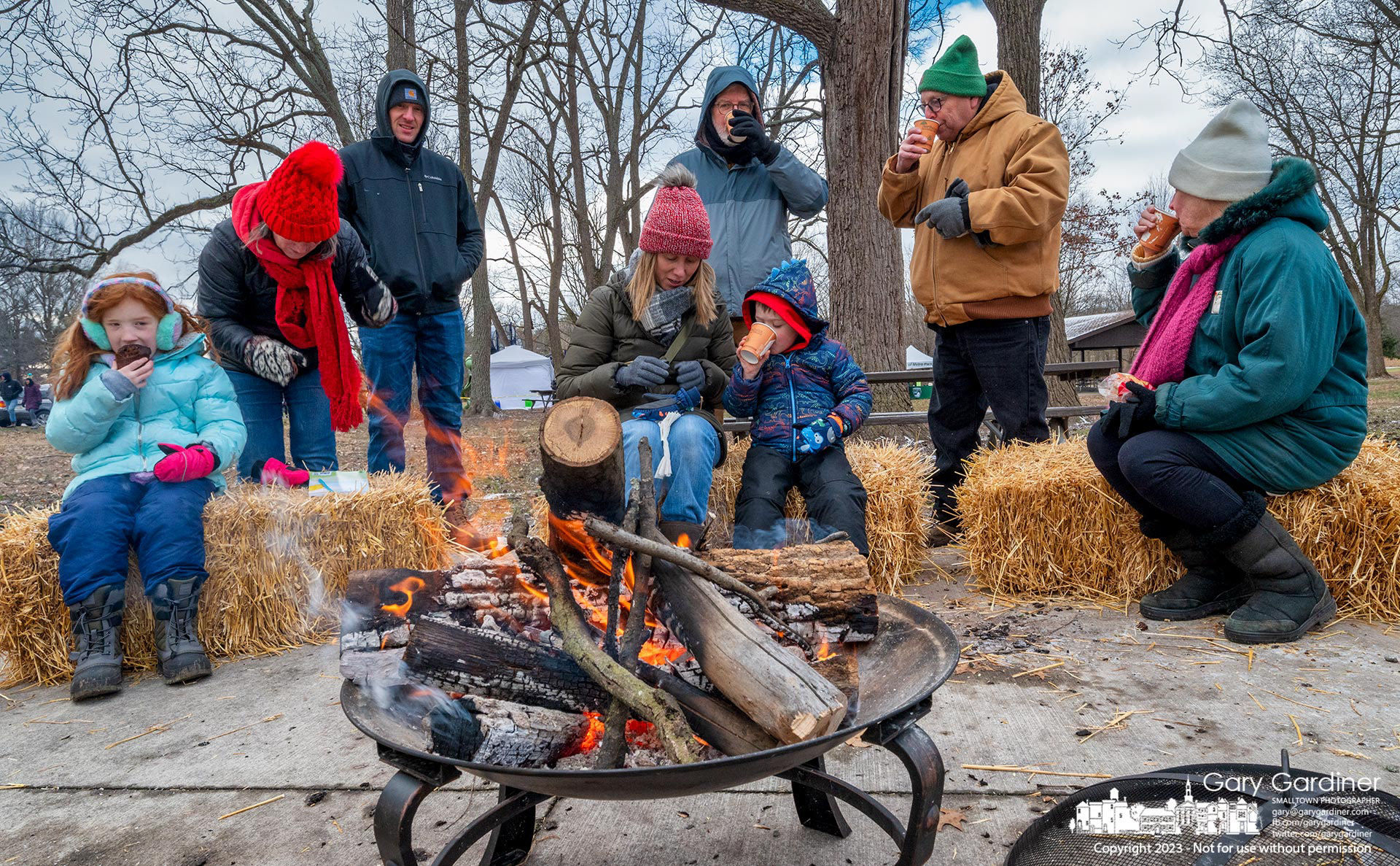 Families gather around a fire and drink hot chocolate after finishing the Winter Hike in Sharon Woods Metro Park Saturday. My Final Photo for January 14, 2023. 