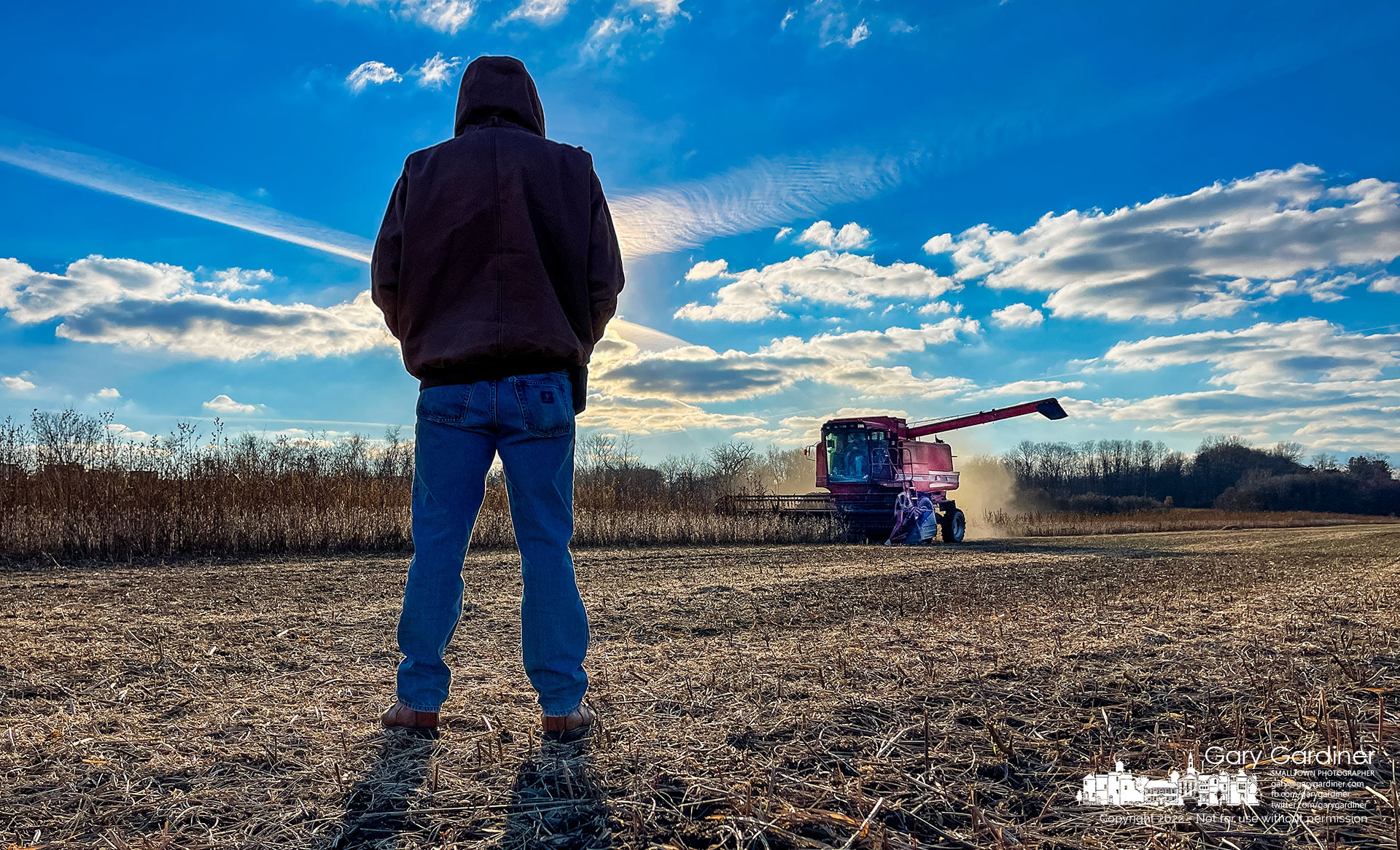 Duane Yarnell watches as Kevin Scott runs his repaired combine through a section of the soybean field below the barn on the Braun Farm. My Final Photo for November 14, 2022.