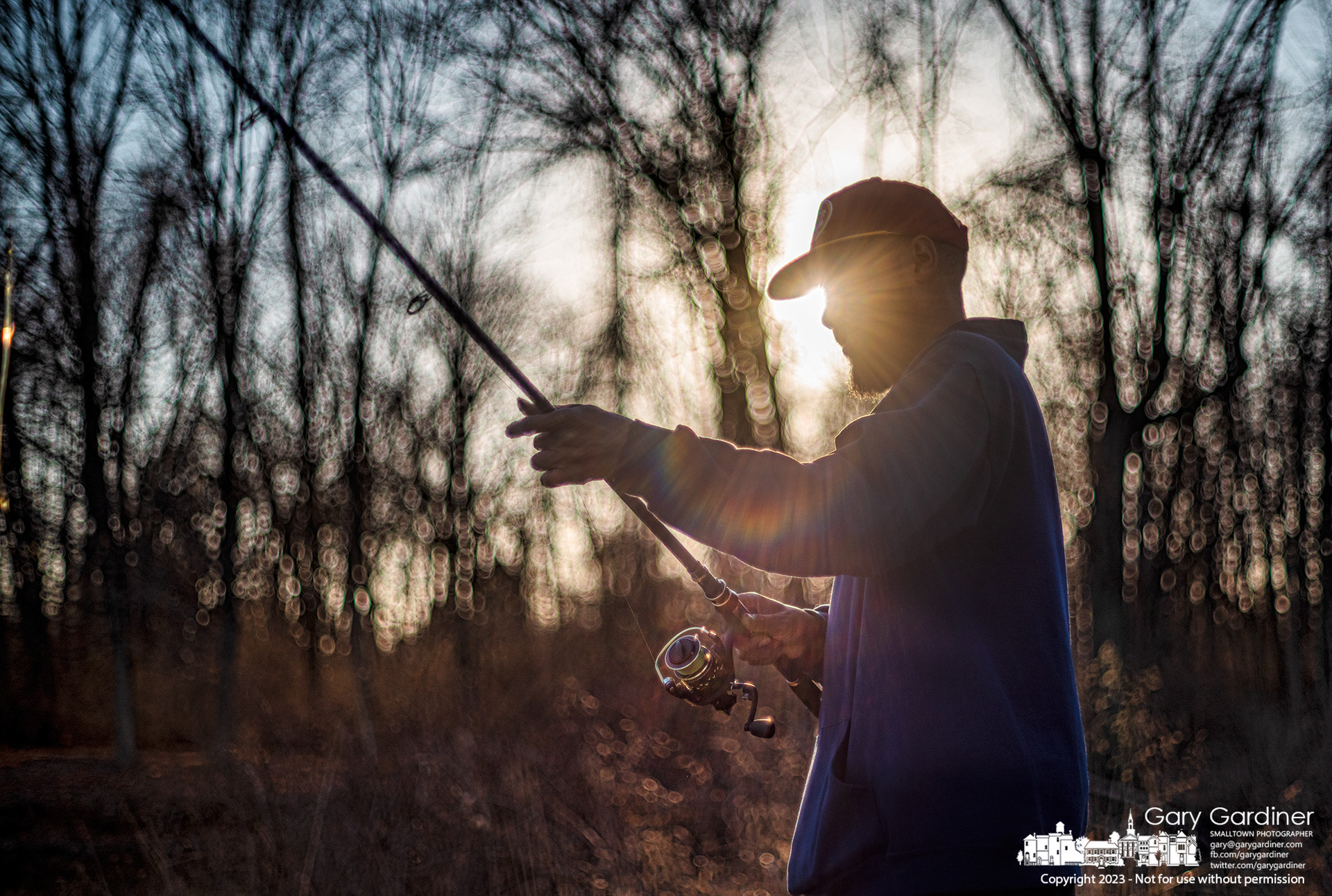 A fisherman adjusts his line before making another toss into the shallows at Rec Bank Park on Hoover Reservoir about an hour before sunset. My Final Photo for February 19, 2023. 