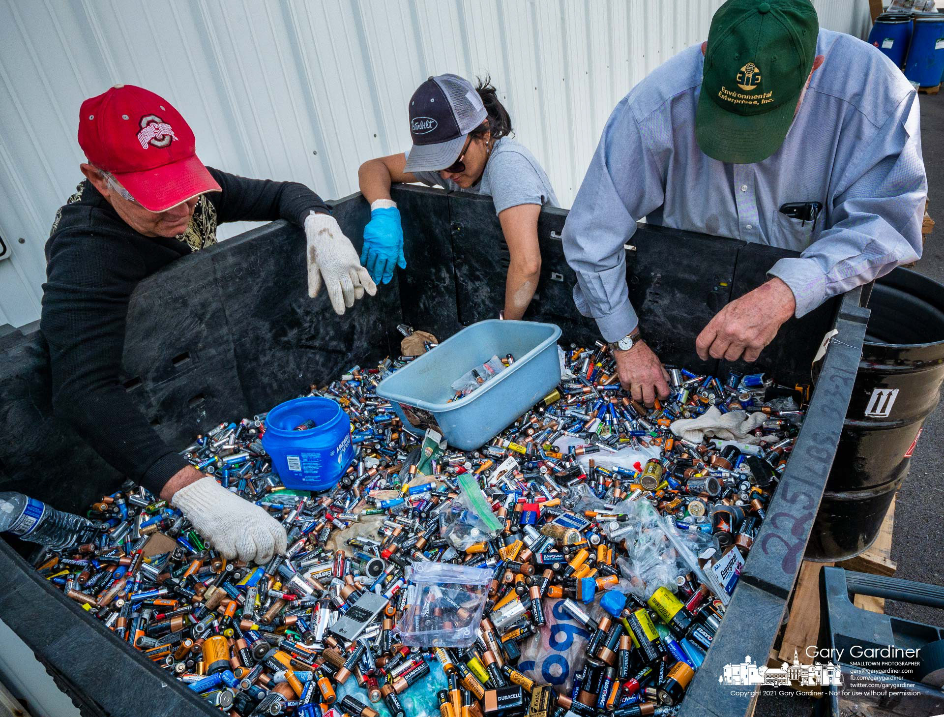 Sorters remove lithium batteries from a bin holding a portion of the batteries left for recycling during the Household Hazardous Waste Disposal drive-thru Saturday. My Final Photo for May 15, 2021.