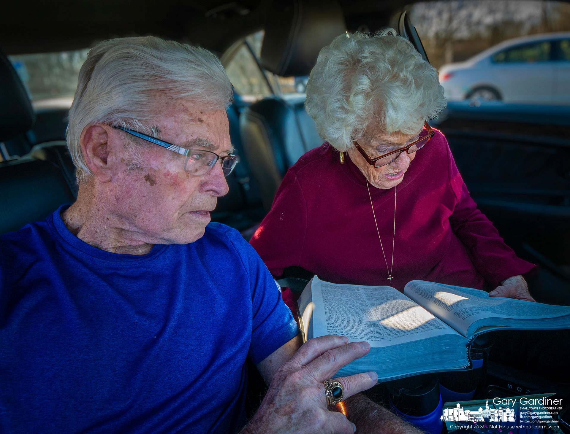 Chuck and Lorretta sit in their car at Red Bank Park as she reads a selection from the Books of Samuel in their Bible. My Final Photo for March 14, 2022.