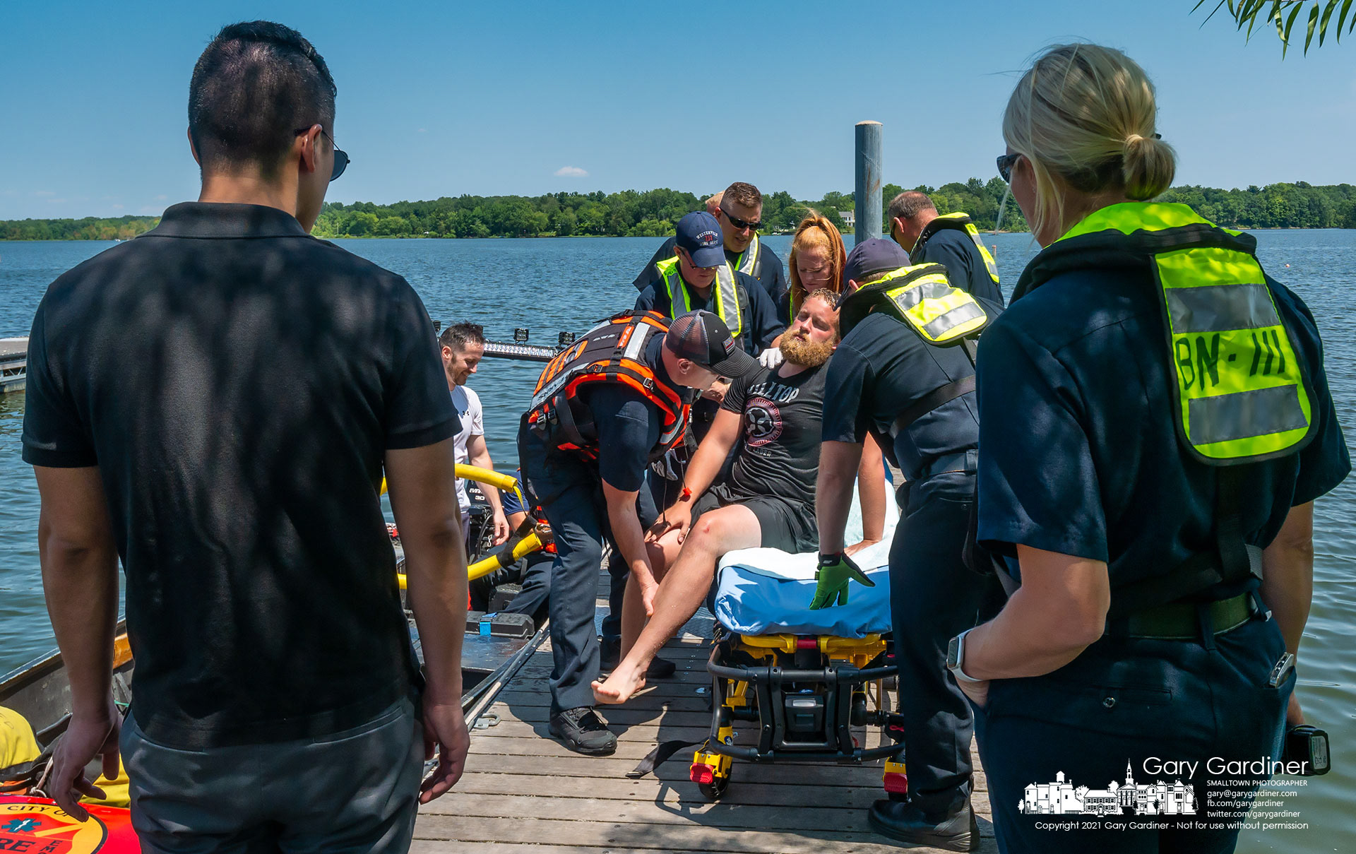 Firefighters move another firefighter to a gurney sitting on the dock at Red Bank Marina under the watch of a doctor and deputy fire chief during water rescue training on Hoover Wednesday. My Final Photo for Aug. 4, 2021.