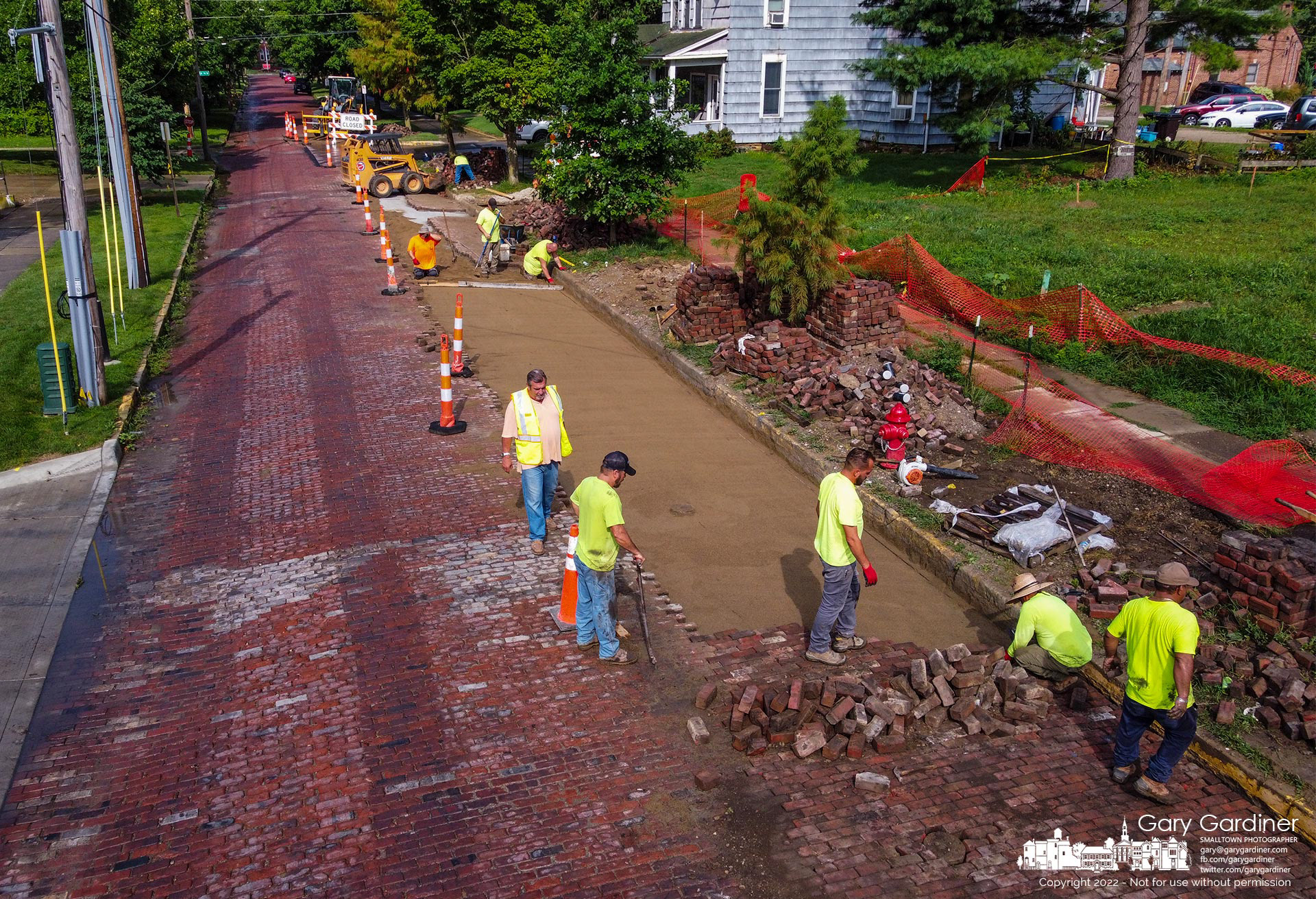 A work crew replaces the bricks removed from West College so a water main could be replaced. My Final Photo for July 28, 2022.