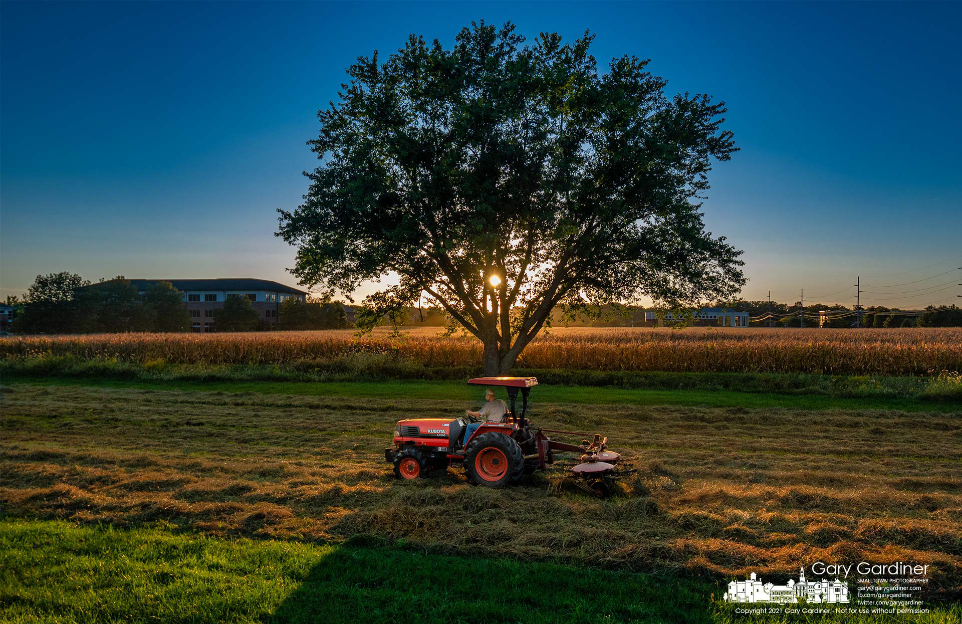 Duane Yarnell rakes hay on the lower section of the small field behind his barn and across the creek from a field of corn. My Final Photo for Sept. 29, 2021.