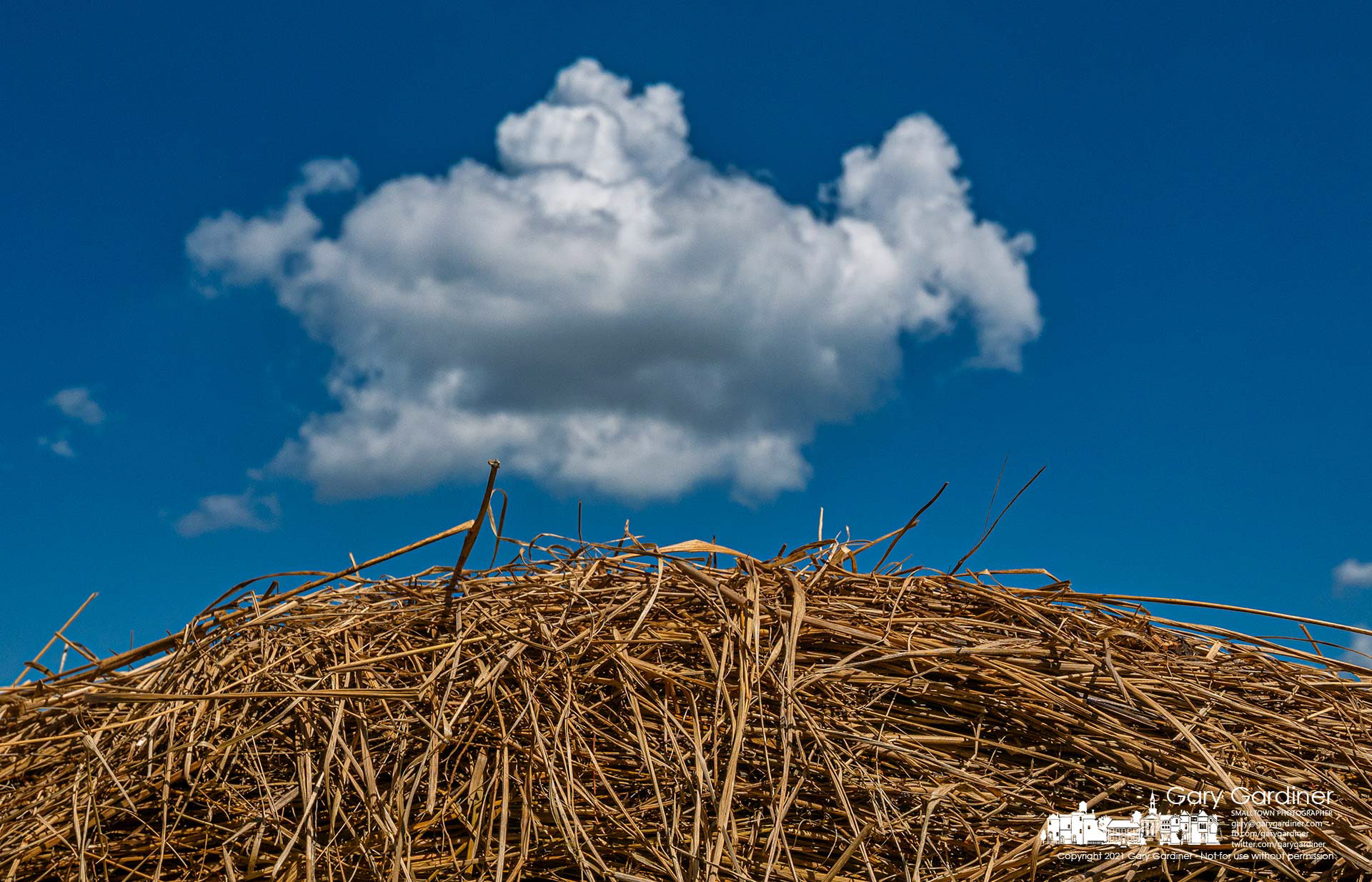 Afternoon clouds travel across a field with scattered bales of late-season hay. My Final Photo for Sept. 17, 2021.