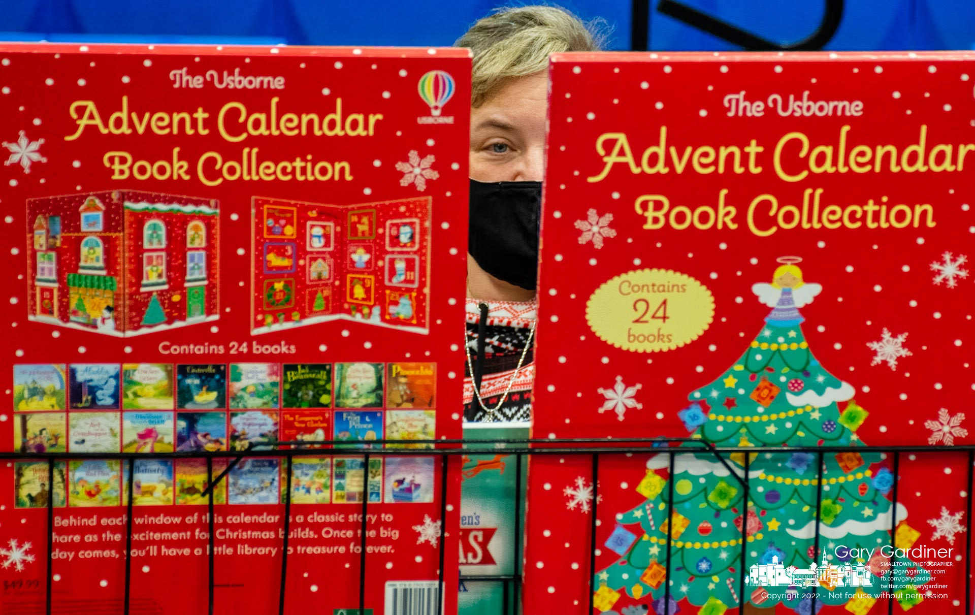 A woman studies a selection of books and calendars while pondering a purchase at the Christmas bazaar at St. Paul the Apostle Catholic Church on Saturday afternoon. My Final Photo for November 19, 2022.