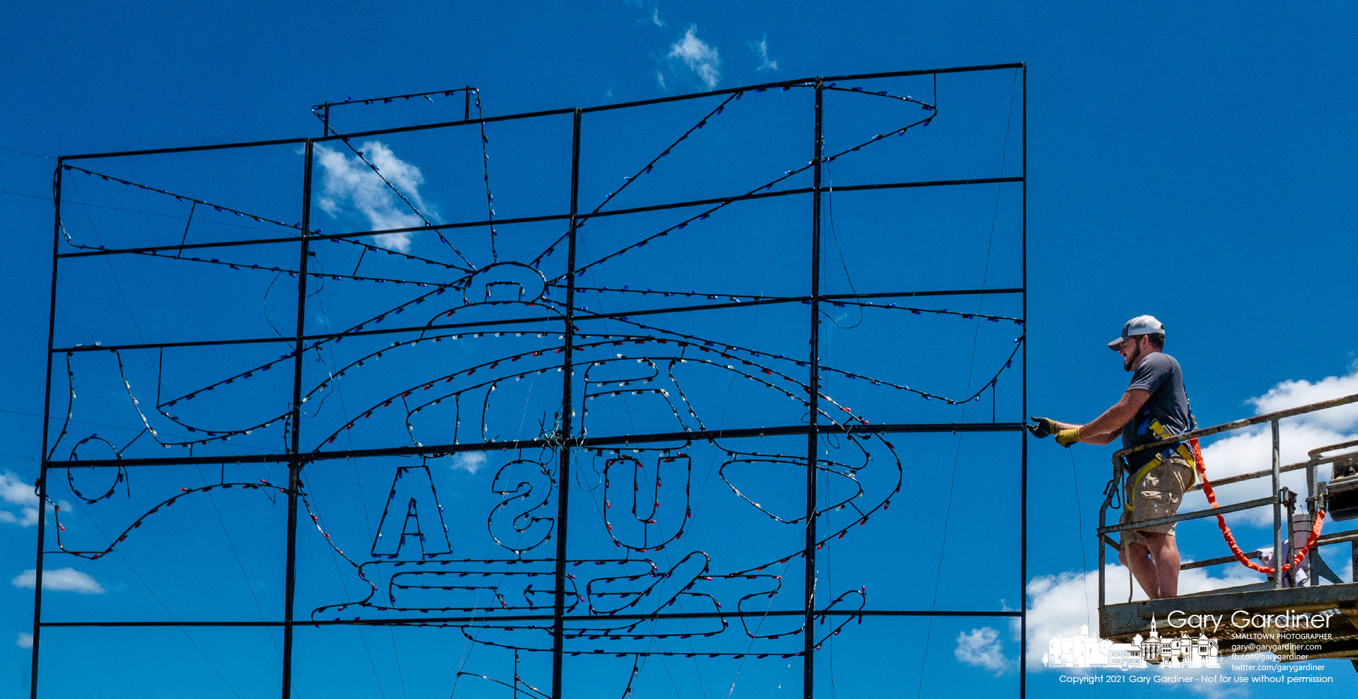 A work crew installs one of the LED light panels that will be part of the Lights of Liberty patriotic display at Westerville North High School beginning Friday night. My Final Photo for June 22, 2021.