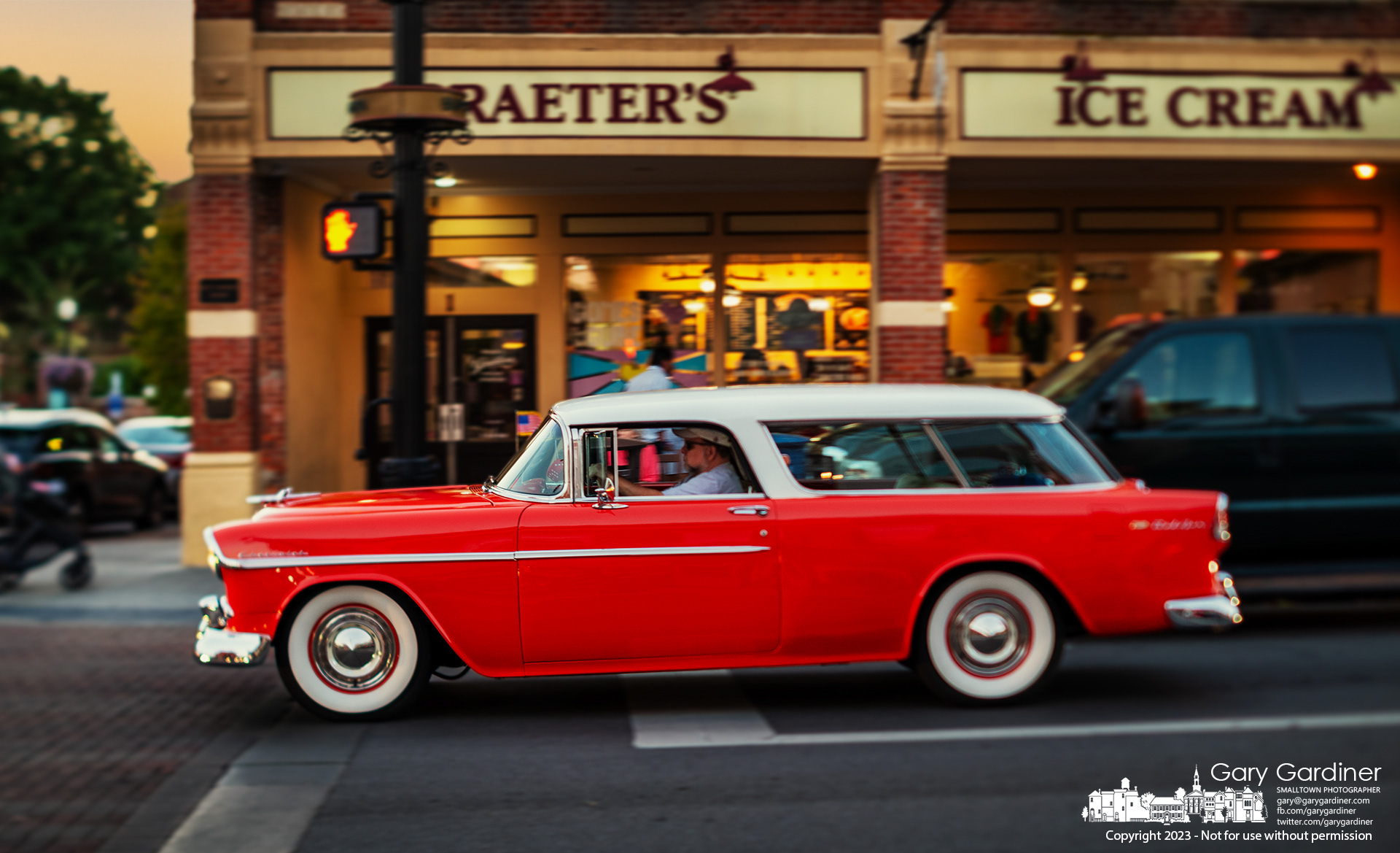 A vintage Chevrolet station wagon travels past Graeter's Ice Cream in Uptown Westerville on Friday night. My Final Photo for September 15, 2023. https://bit.ly/48toYzo