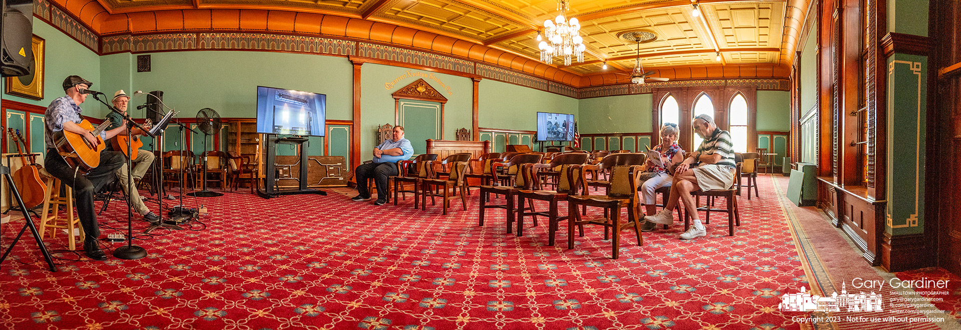 Tapestry of the Town participants listen and watch in the Philomathean Room in Towers Hall at Otterbein University to one of two sets of performers who greeted them at this location in the tour of historical buildings in Westerville. My Final Photo for July 30, 2023.