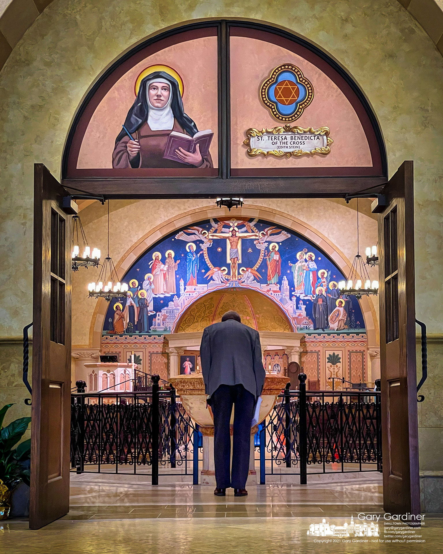 A parishioner bows as he enters St. Paul the Apostle Catholic Church for early Sunday Mass. My Final Photo for May 16, 2021.