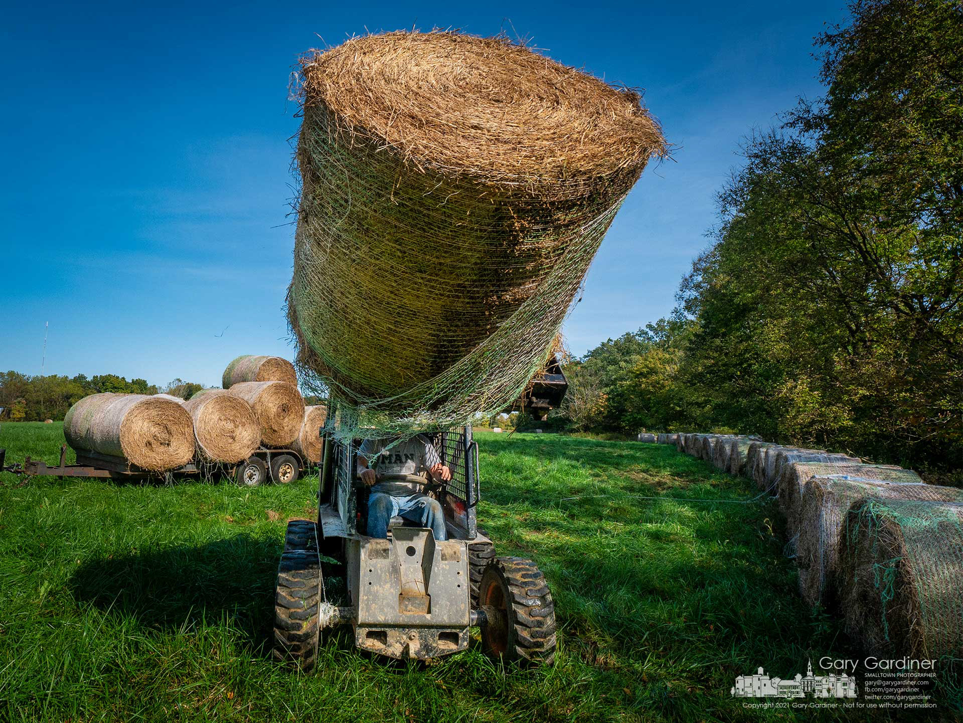 Round hay bales are moved to the edge of the field for temporary storage and to allow the field to grow for what may be another fresh cut before winter. My Final Photo for Oct. 13, 2021.