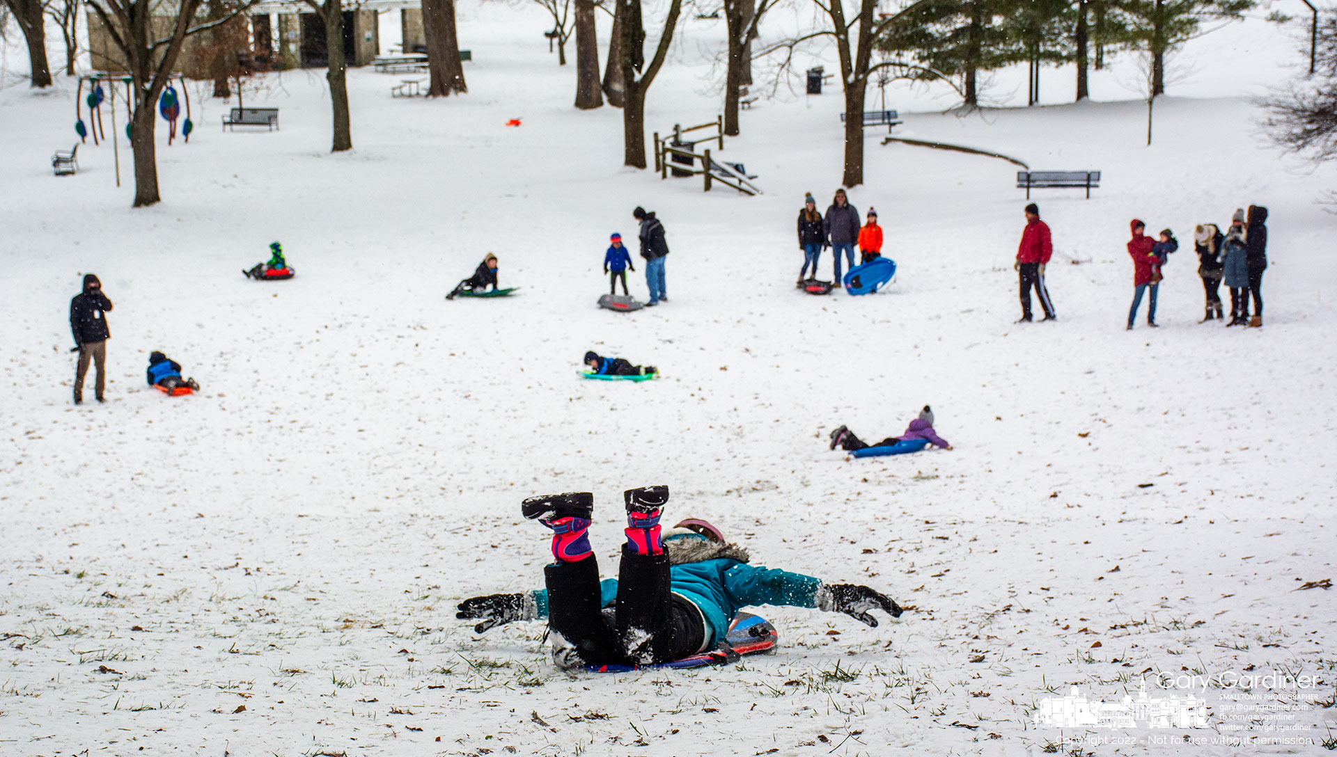 A youngster races down the sledding hill at Alum Creek North with hands and feet off the ground after propelling herself down the small slope. My Final Photo for Jan. 17, 2022.