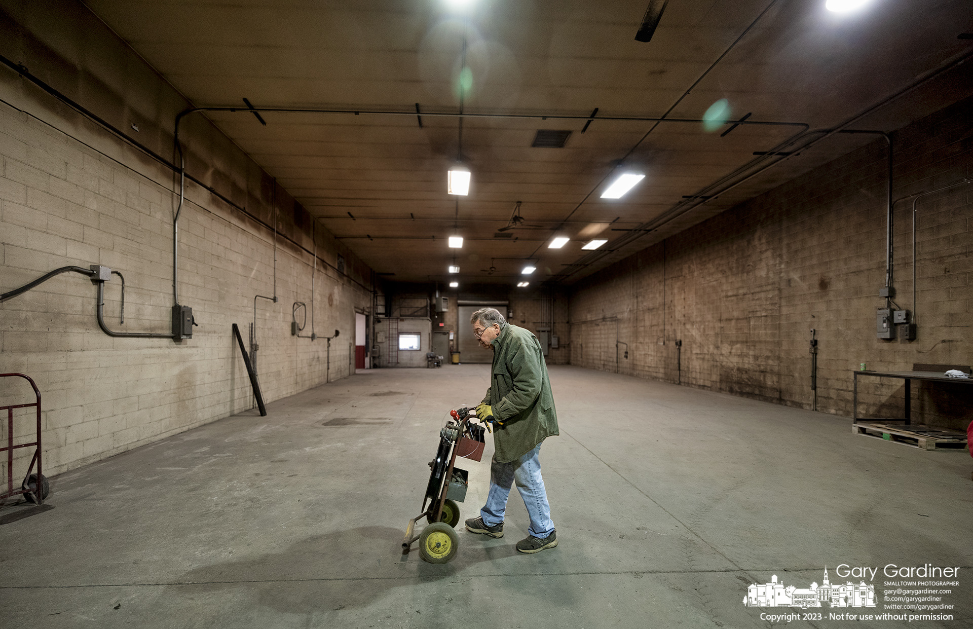 Jim Hance moves a roll of metal strapping tape across the nearly empty floor of En-Hanced where about two weeks ago the floor of Westerville's oldest business was filled with machines, tools, rigs, jigs, and sheets of metal before the company stopped producing custom-built industrial equipment. My Final Photo for February 24, 2023. 