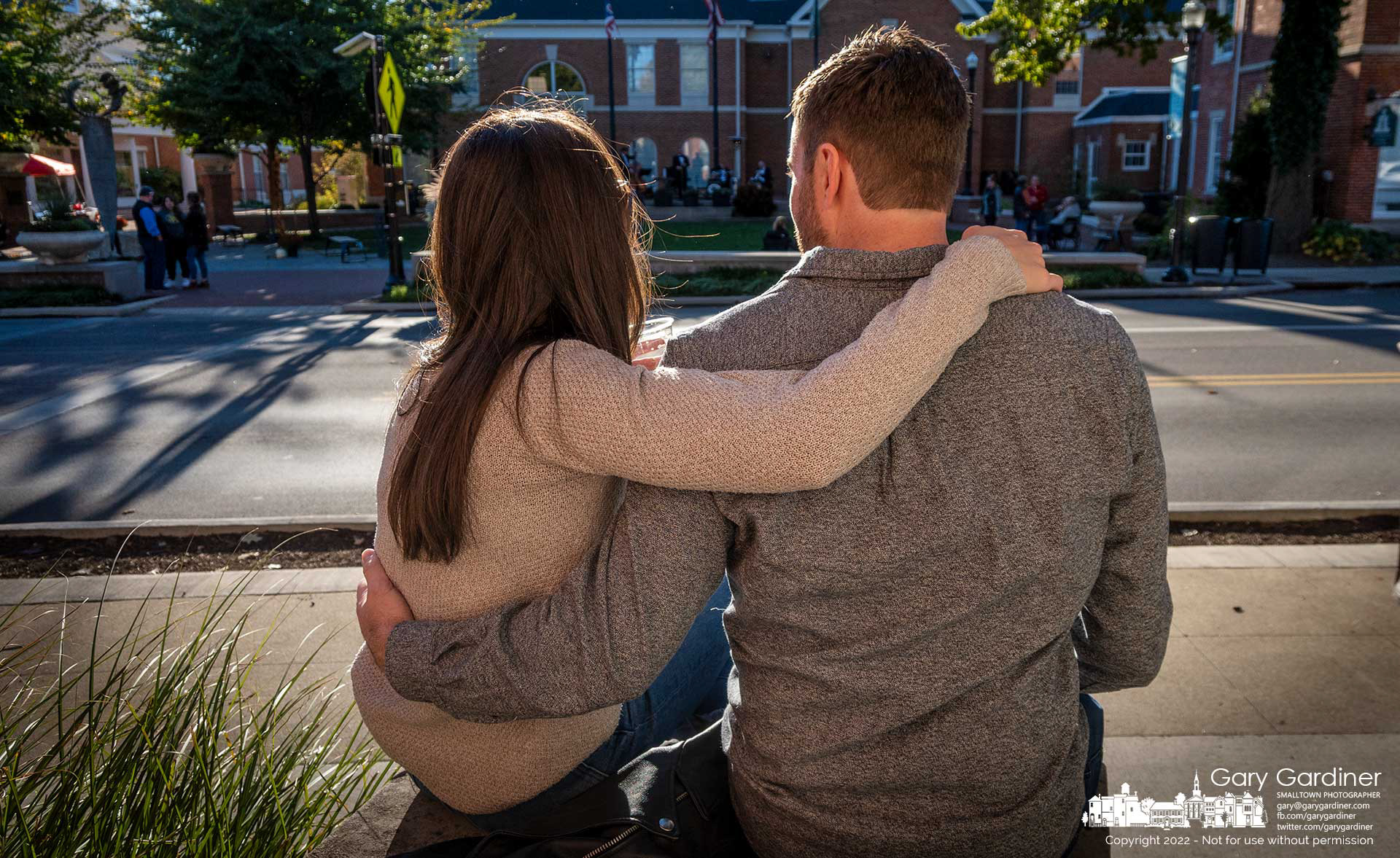 A couple sits arm-in-arm enjoying DORA drinks across the street from city hall where a Dean Martin tribute band played as part of the Ohio Valley Hometown Reunion in Uptown Westerville. My Final Photo for Oct. 8, 2022.