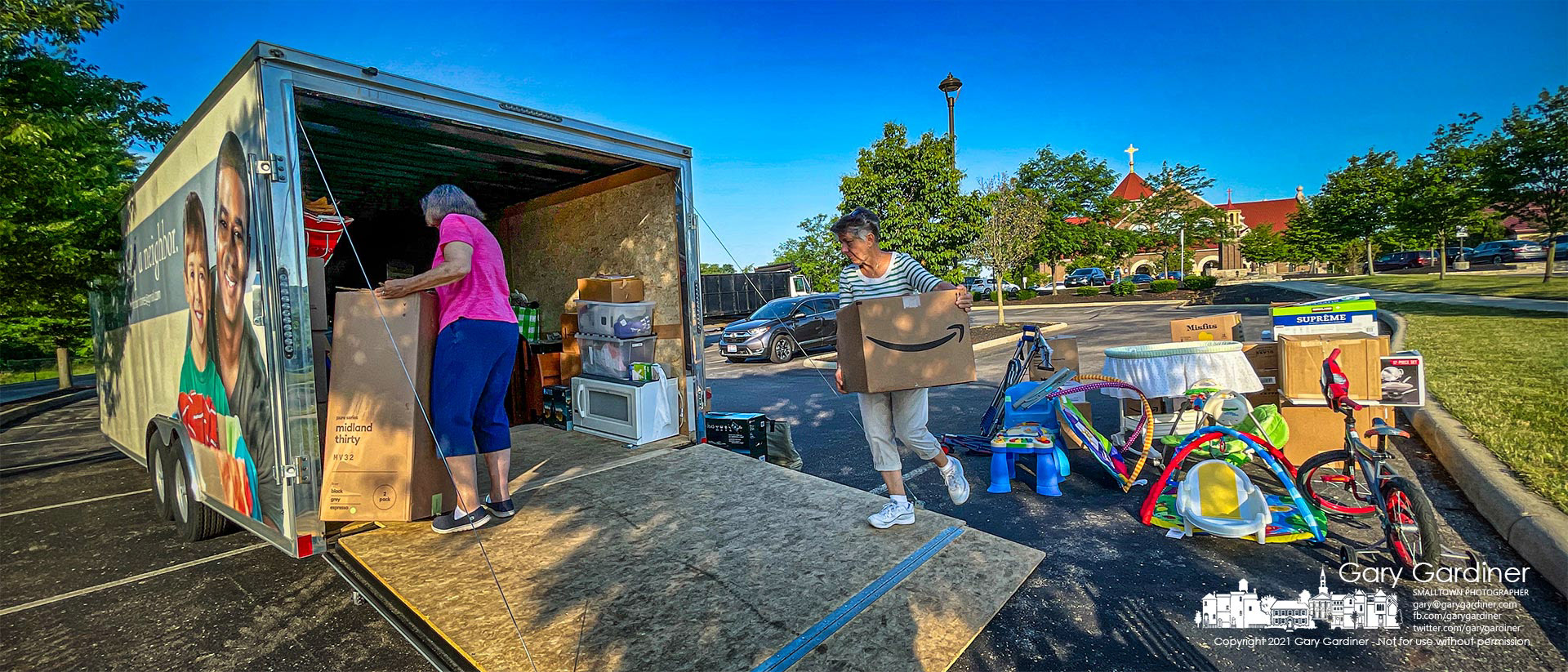 Volunteers sort through the collection of clothing, toys, and household items donated to the St. Vincent DePaul Society during services Sunday at St. Paul the Apostle Catholic Church. My Final Photo for June 27, 2021.