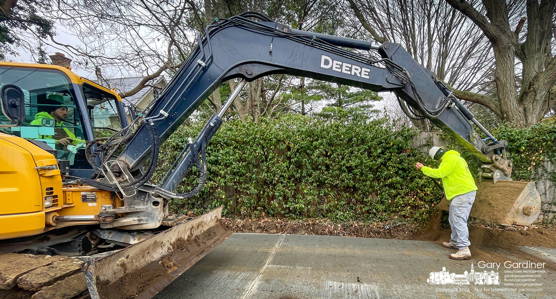 A landscaping crew puts fill dirt into the edge of a new concrete alleyway poured during the upgrade and reconstruction of East Home Street. My Final Photo for November 15, 2022.