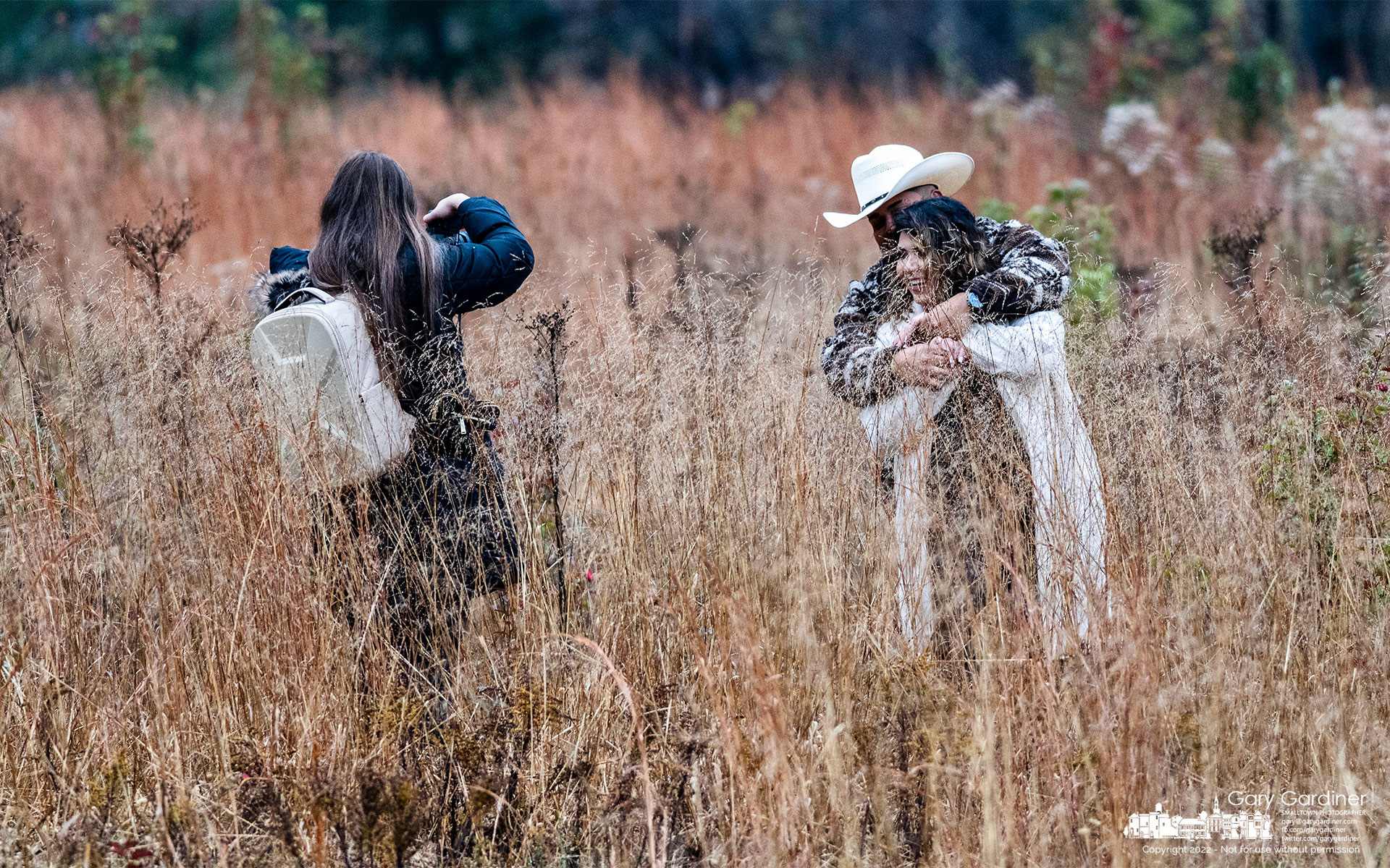 A couple poses for photos in the tall grass between the fairways at the disc golf course at Hoover reservoir. My Final Photo for November 12, 2022.
