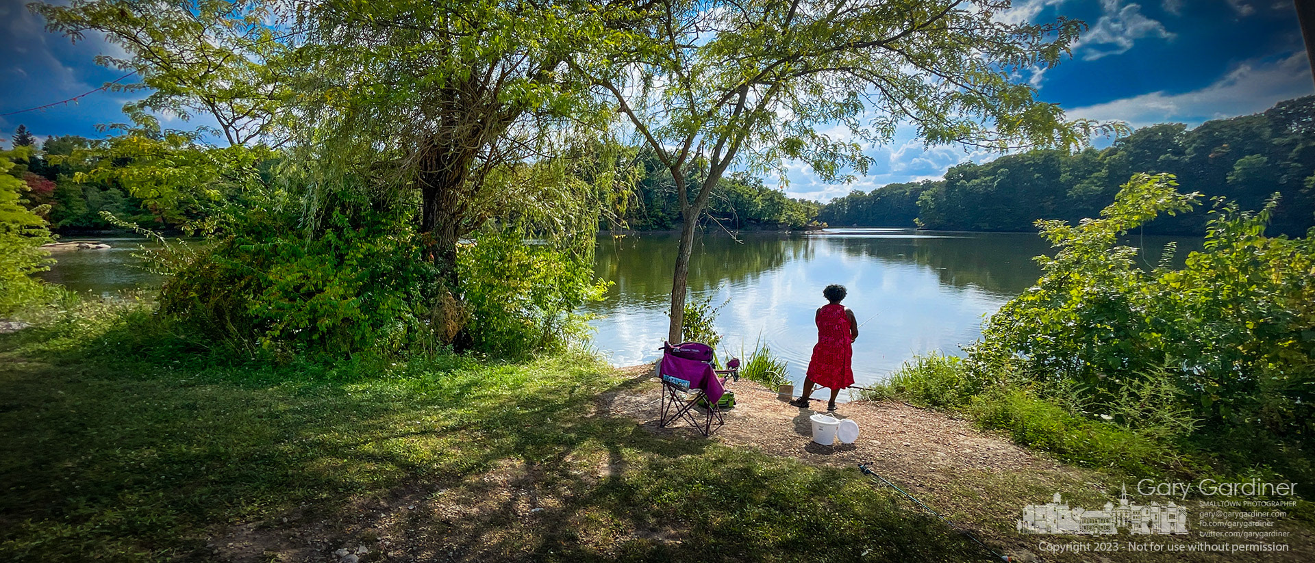 A woman stands with two lines in the water of Hoover Reservoir where she and her friends are hoping for the good luck that a day fishing might bring. My Final Photo for September 17, 2023.  #Westerville  #westervilleohio  #westervillenews  #uptownwestervilleohio #wvloh #ohio #f8wwwwwh #wwwwwh #f8 #everydayohio  #ohiopix  #ohio  #everydayusa  #apad