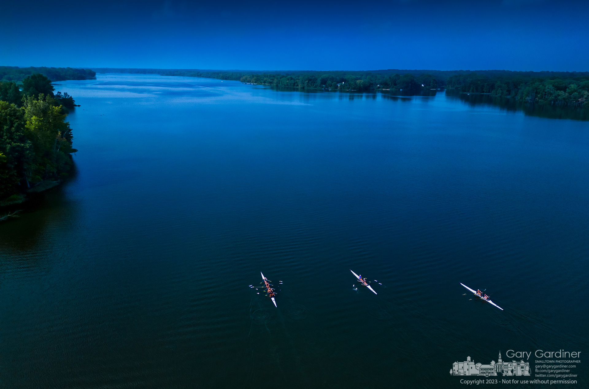 Three Westerville Crew boats sit idle during a break in training Tuesday on the near perfectly still waters of Hoover Reservoir. My Final Photo for July 24, 2023.