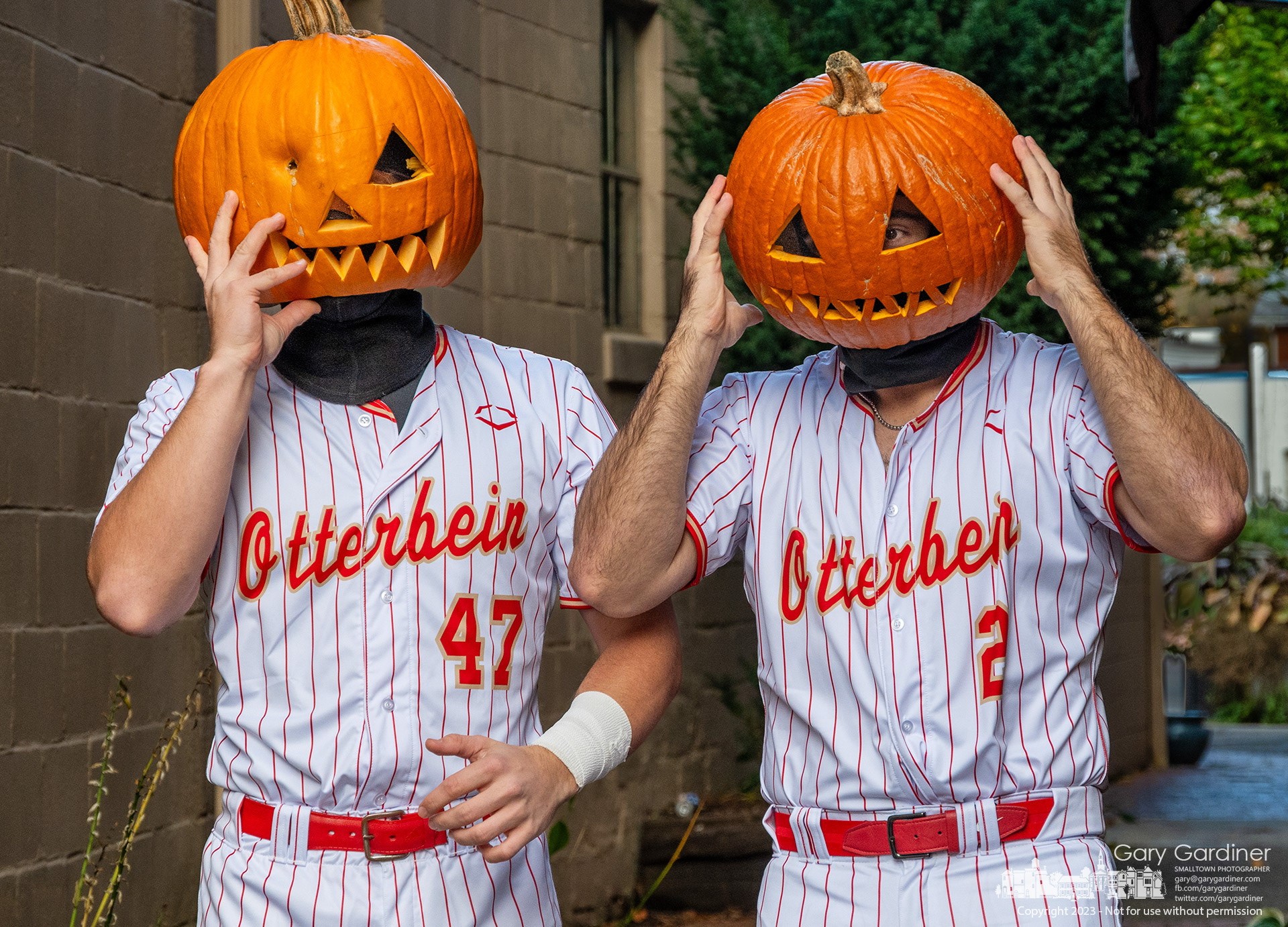 A pair of Otterbein University baseball players wanted photos from an accompanying friend to show off the team's new uniforms and used hollowed-out jack-o-lantern pumpkins as unofficial additions to the look for only one day. My Final Photo for October 31, 2023. https://bit.ly/3QiuvAl
