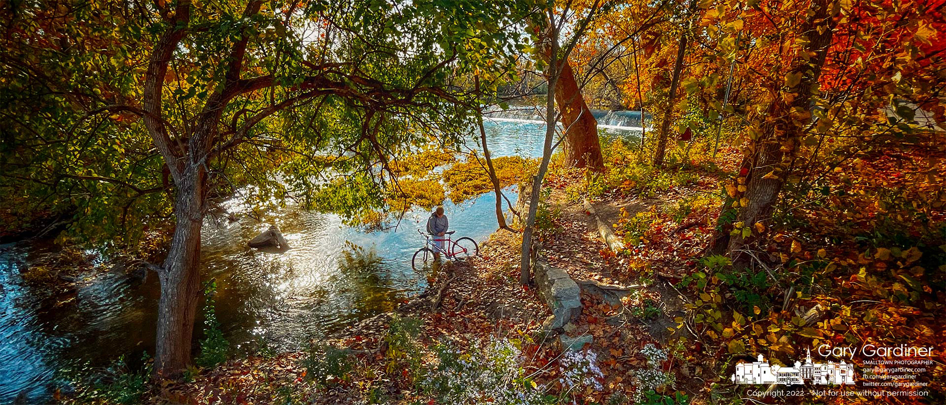 A young fisherman keeps his chain from dropping into Alum Creek, getting wet, and risking rust as he returns from a brief fishing trip to the island below the low-head dam. My Final Photo for October 21, 2022.