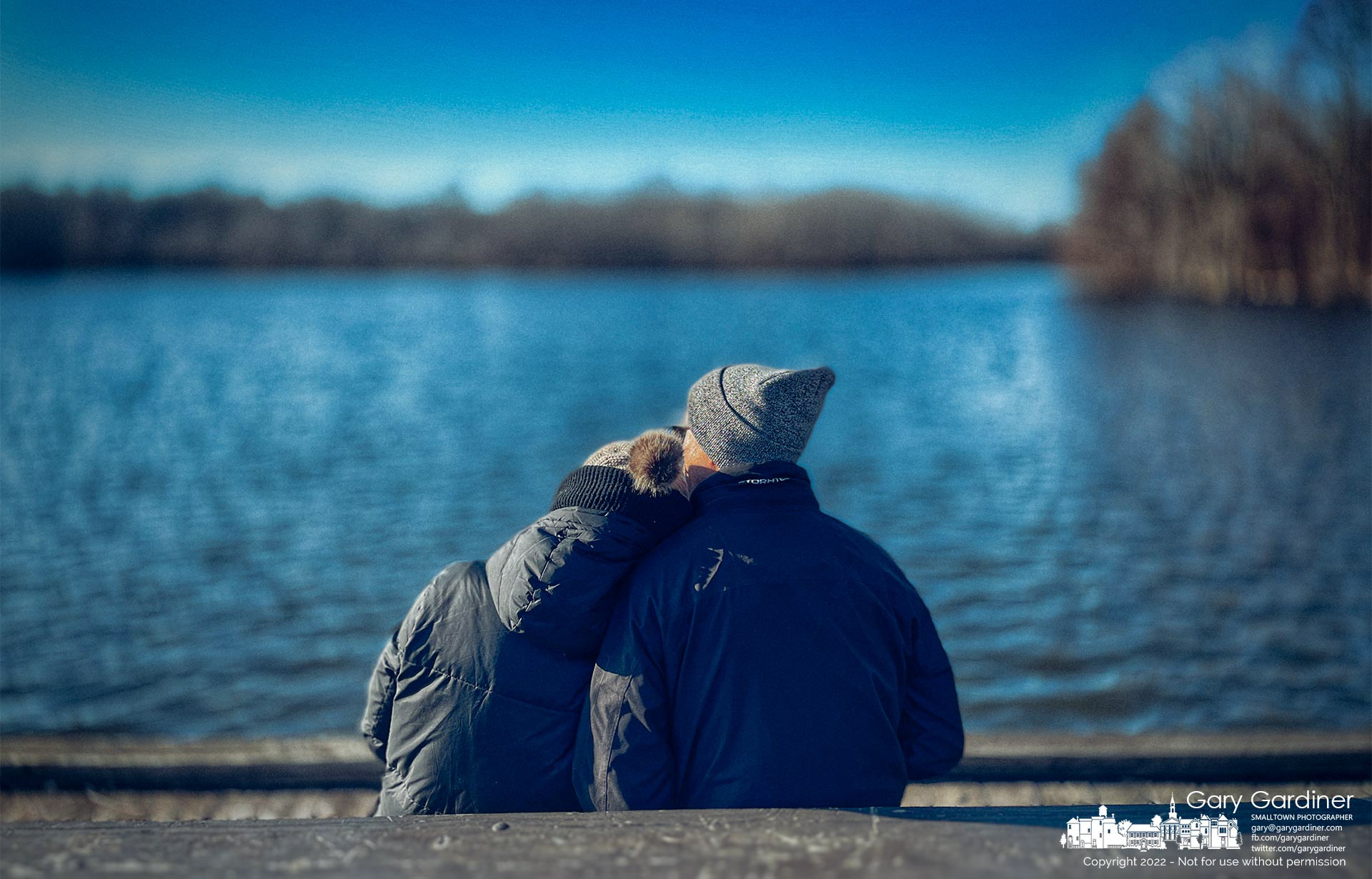 A couple shares a bench, their affection for each other, and a brisk wind blowing across Schrock Lake at Sharon Woods Park on Sunday afternoon. My Final Photo for Feb. 27, 2022.
