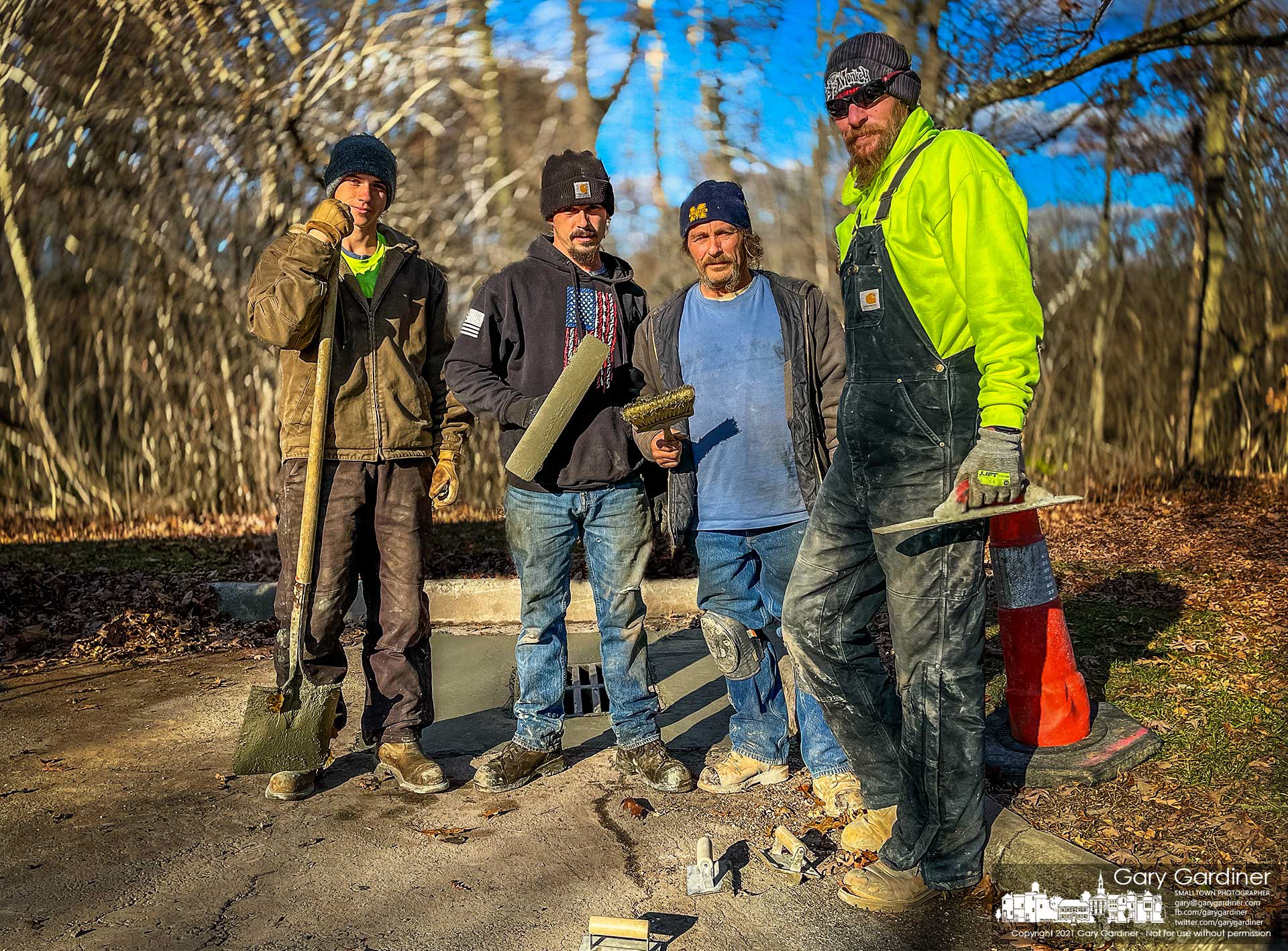 The four men working for a construction company pose for a photo after pouring a concrete pad around a drain in one of the parking lots at Sharon Woods Metro Park. My Final Photo for Nov. 23, 2021. 
