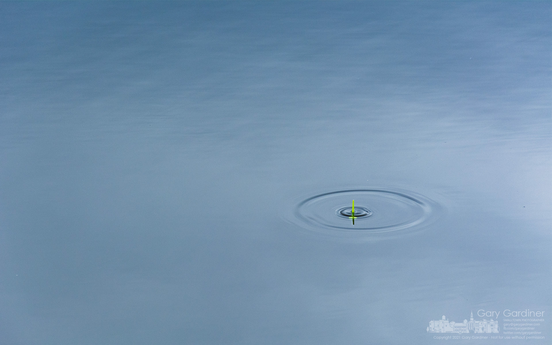 An angler's floater ripples the still waters of Hoover Reservoir from the attempts at an underwater prey to grab the bait hanging from a hook. My Final Photo for Dec. 17, 2021.