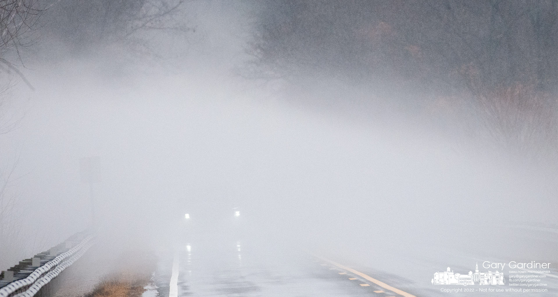 A car travels through a layer of fog blowing across the Sunbury Road bridge over Hoover Reservoir where rain and slightly warmer temperatures began melting ice covering the lake creating unexpected hazardous driving conditions. My Final Photo for Feb. 17, 2022.