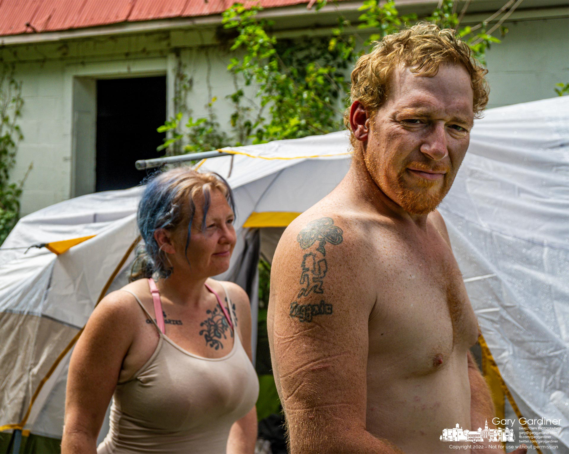 A homeless couple stands outside their tent pitched overnight Monday behind the barn at the Braun Farm after they say they were kicked out of their apartment on Route 161. My Final Photo for Sept. 4, 2022.
