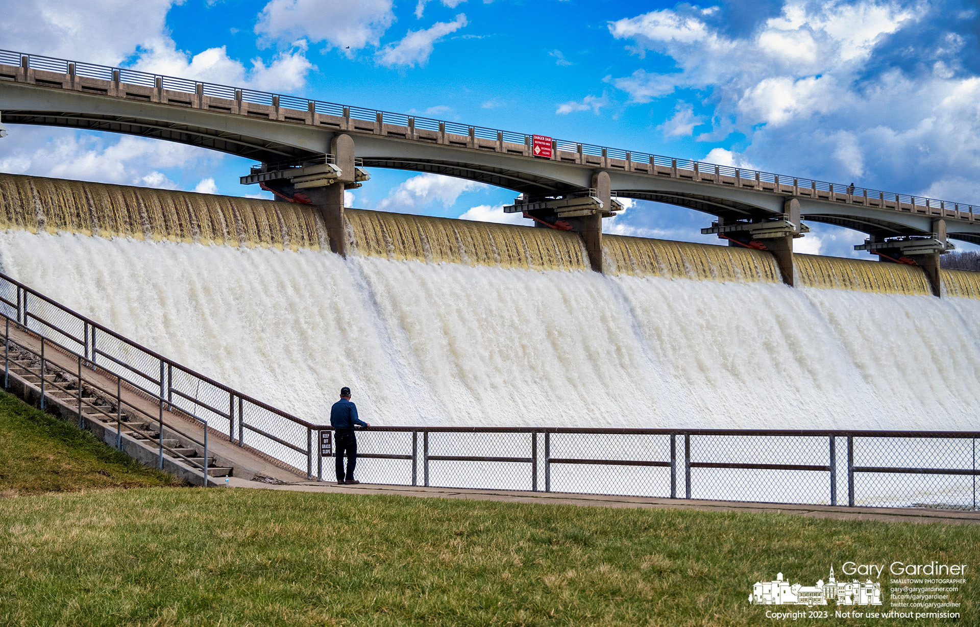A man pauses walking the steps at Hoover Dam to study the heavy flow of water over the spillway after heavy rain fell on the already-soaked ground and waterways raising the level of the reservoir. My Final Photo for March 25, 2023.  
