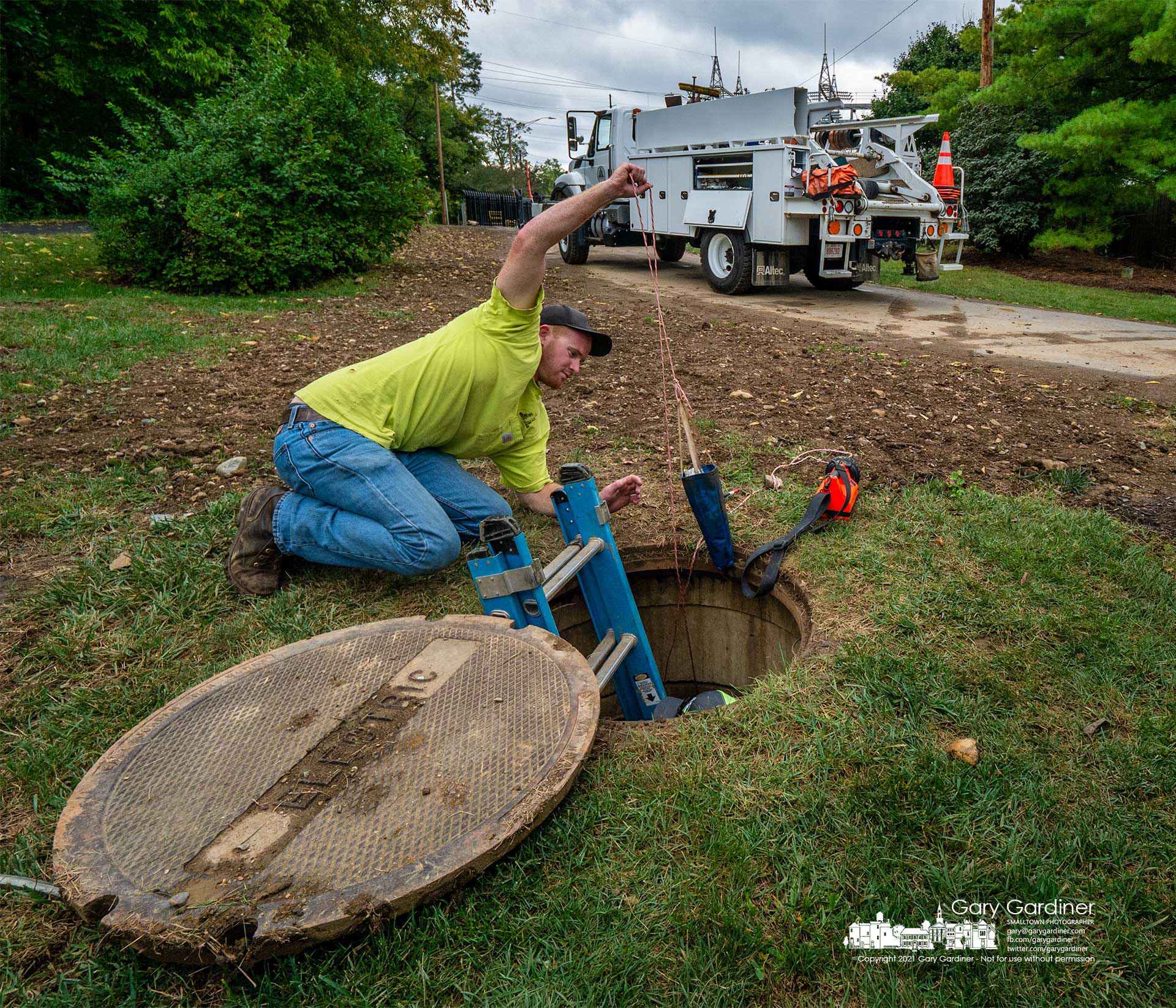 A city electric worker removes the canvas bird used to pull a cable through recently laid conduit that will hold new three-phase wire going to the upgraded power sub-station off Collegeview. My Final Photo for Sept. 21, 2021.