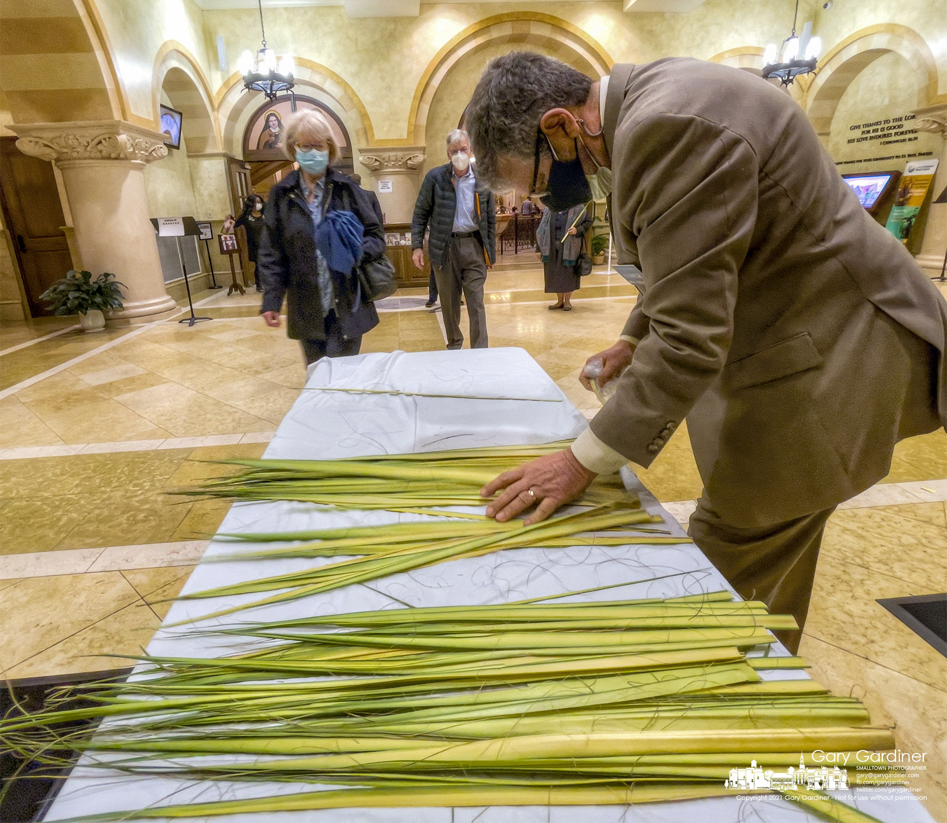An usher at St. Paul the Apostle Catholic Church separates palm fronds for parishioners attending Palm Sunday Mass at the Westerville, Ohio church. My Final Photo for March 28, 2021.