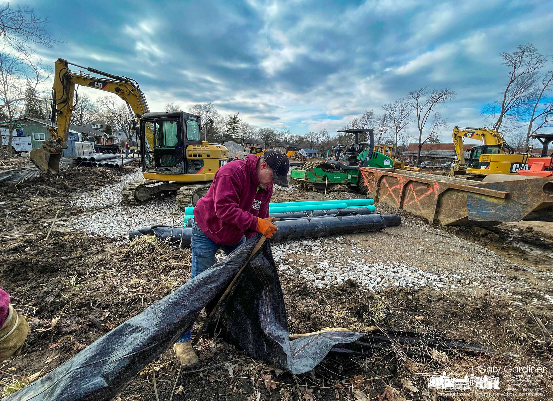 A contractor ends his day by resetting a section of silt fence along the back corner of an office and apartment complex being built on South State Street adjacent to the old post office. My Final Photo for March 8, 2022.