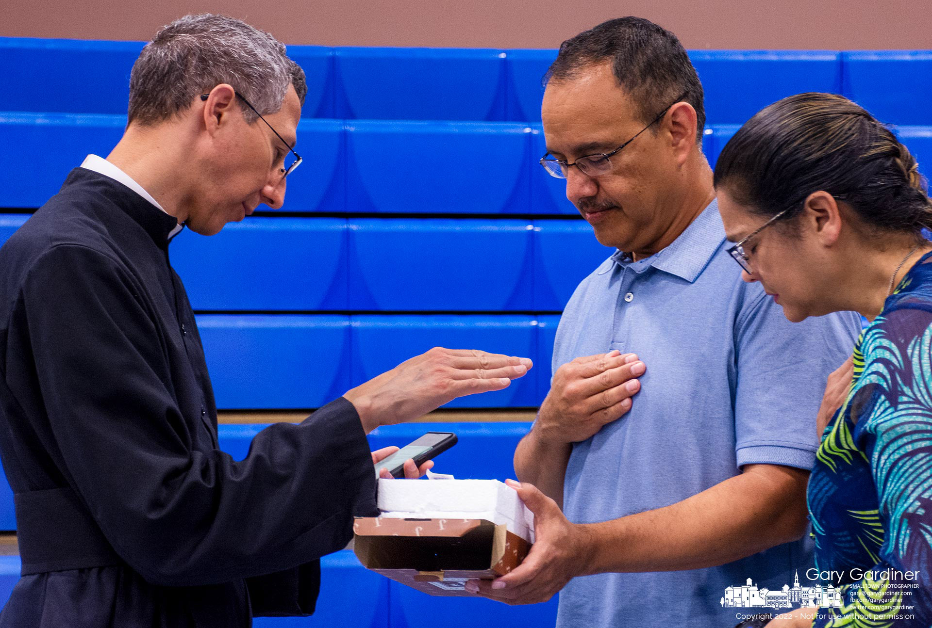 Fr. Daniel Olvera issues a blessing for a parishioner's new crucify during a reception after the new parochial vicar for St. Paul gave his first Sunday Mass. My Final Photo for July 17, 2022.