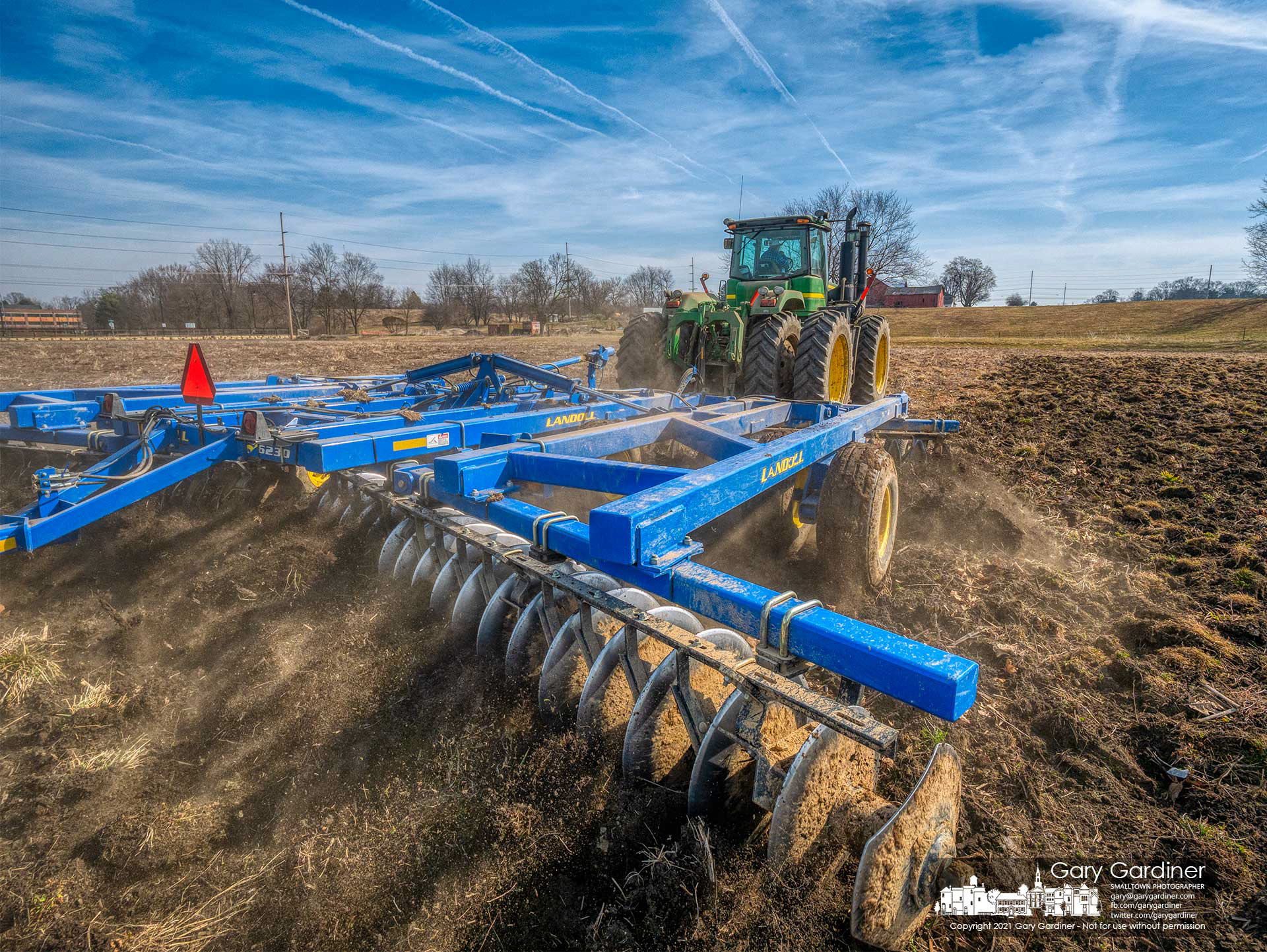 A farmer runs a disc plow over the field beneath the Yarnell Farm on Africa Road preparing for planting of corn after missing last year's planting season because of the heavy rains. My Final Photo for March 10, 2021.