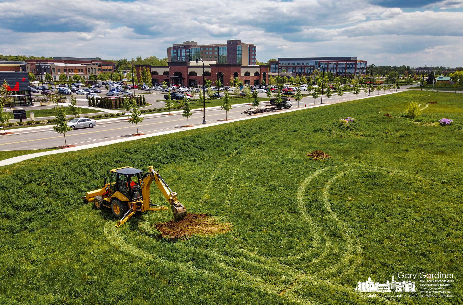 A back-hoe operator fills one of the test trenches dug into an undeveloped section of Westar at the corner of Cleveland and Polaris where developers are exploring new business construction. My Final Photo for May 14, 2021.